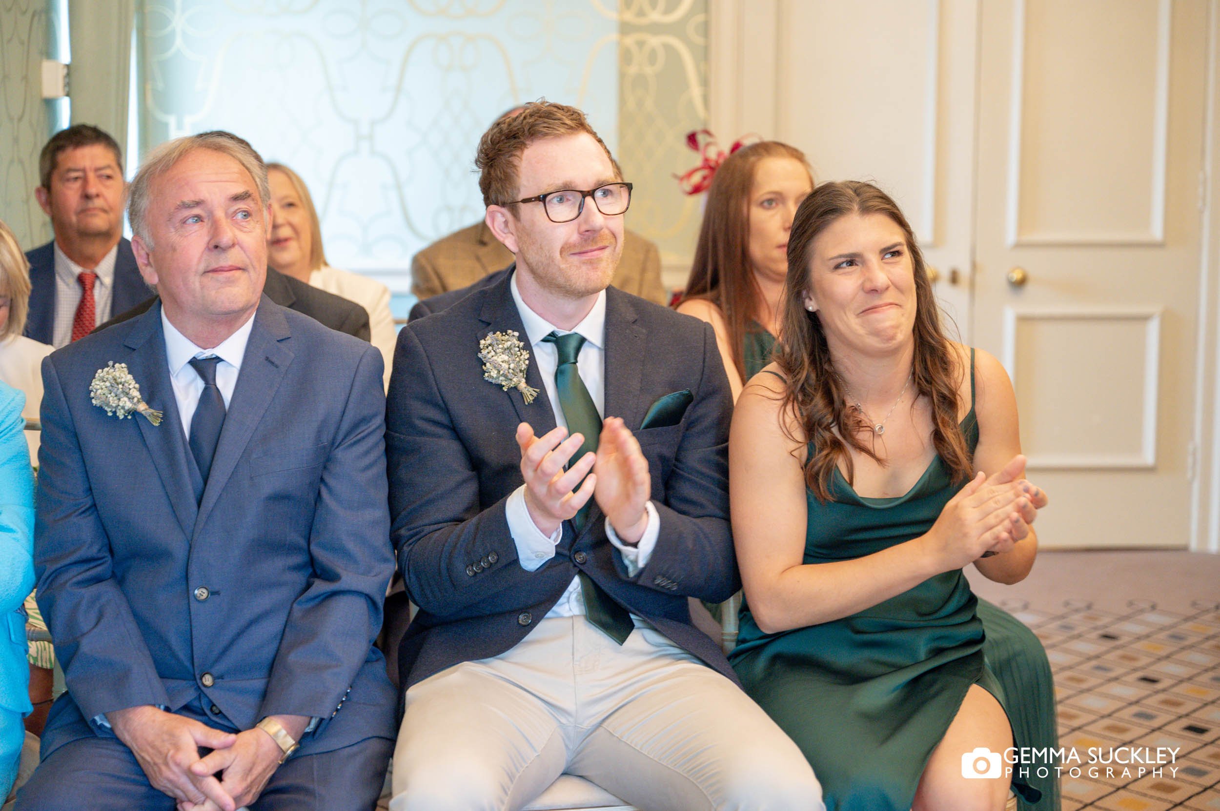 wedding guests clapping after bride and groom are wed