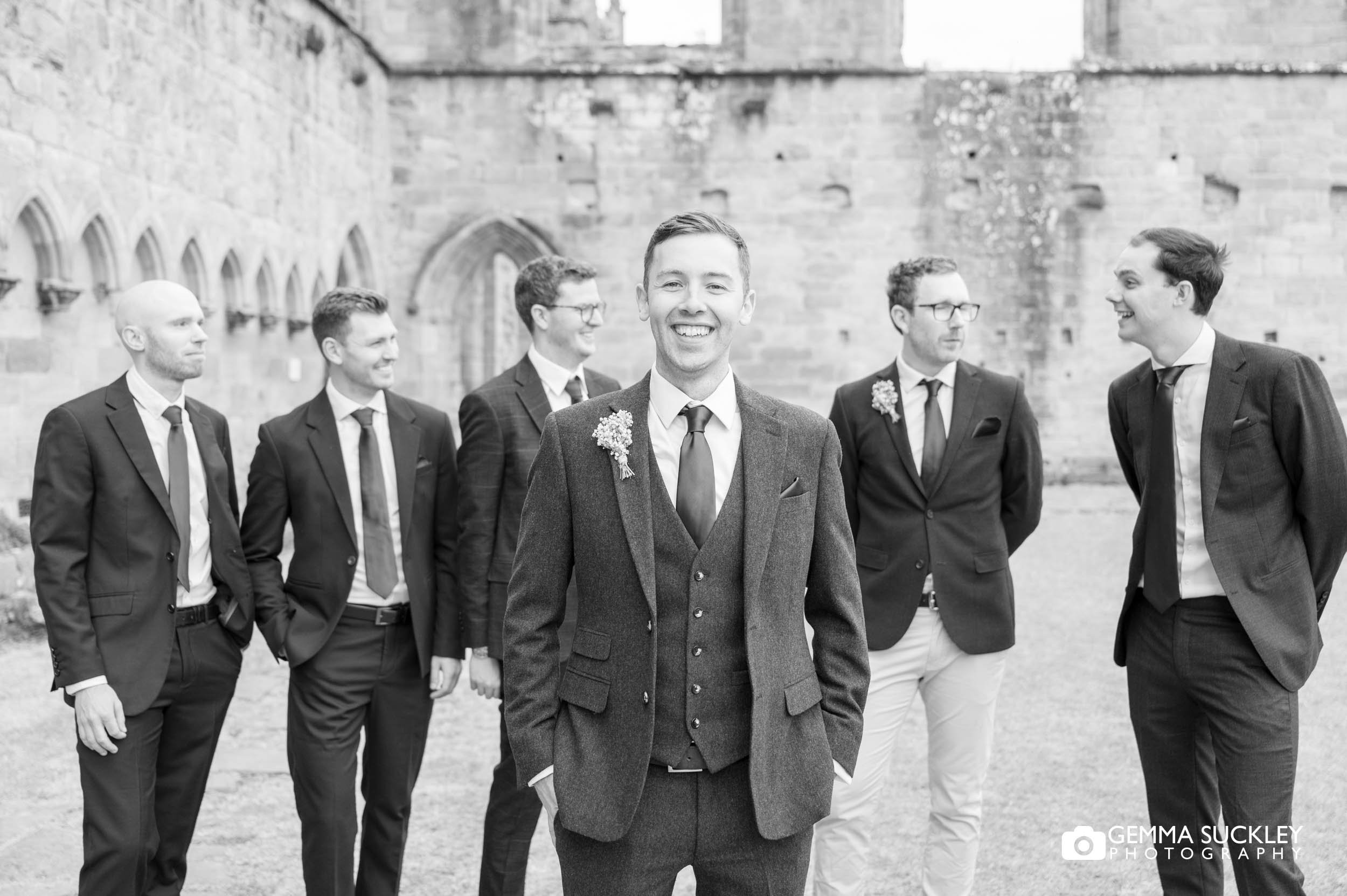 groom as groomsmen at bolton abbey priory ruins