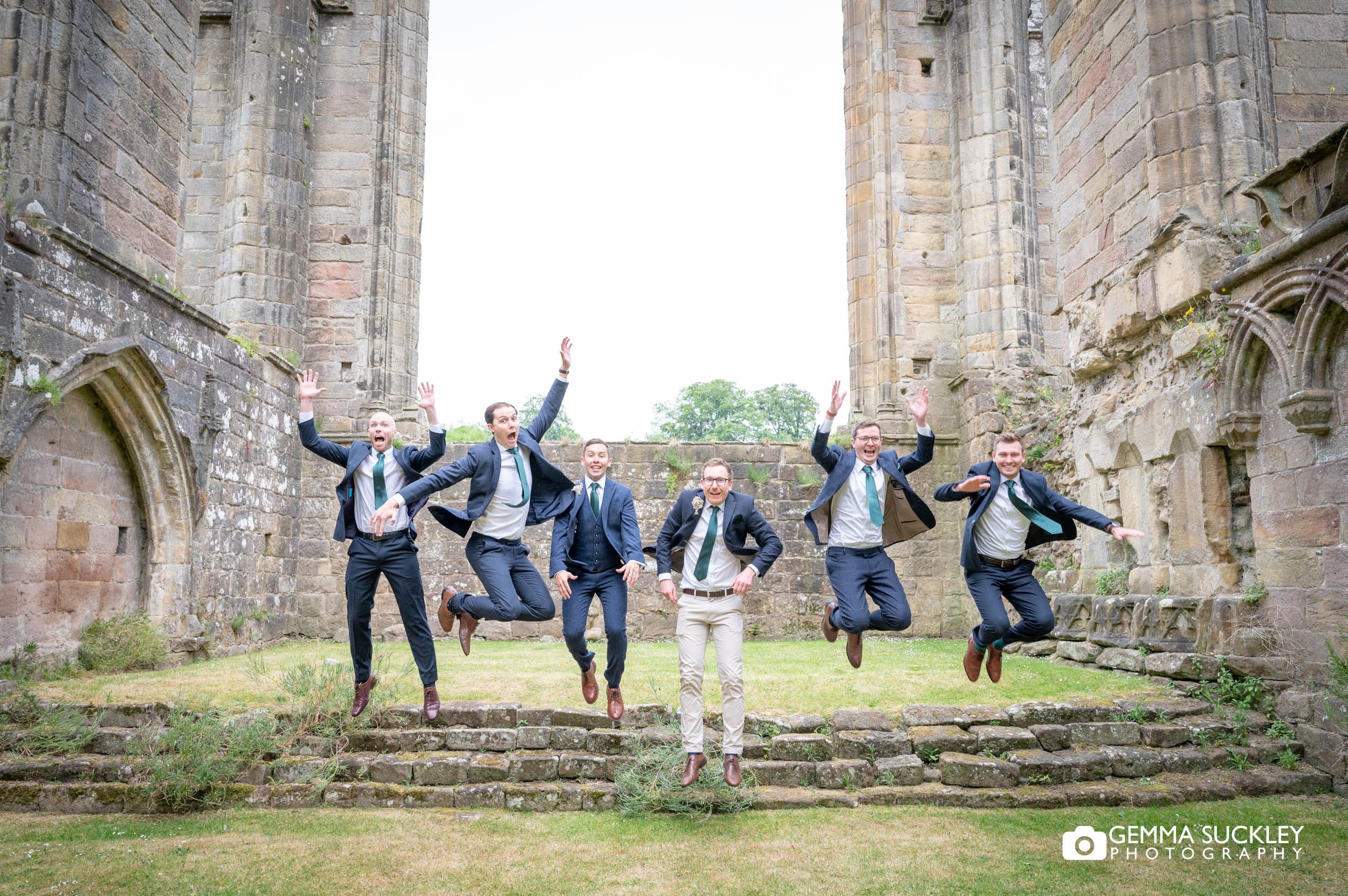 grooms party jumping for a wedding photo