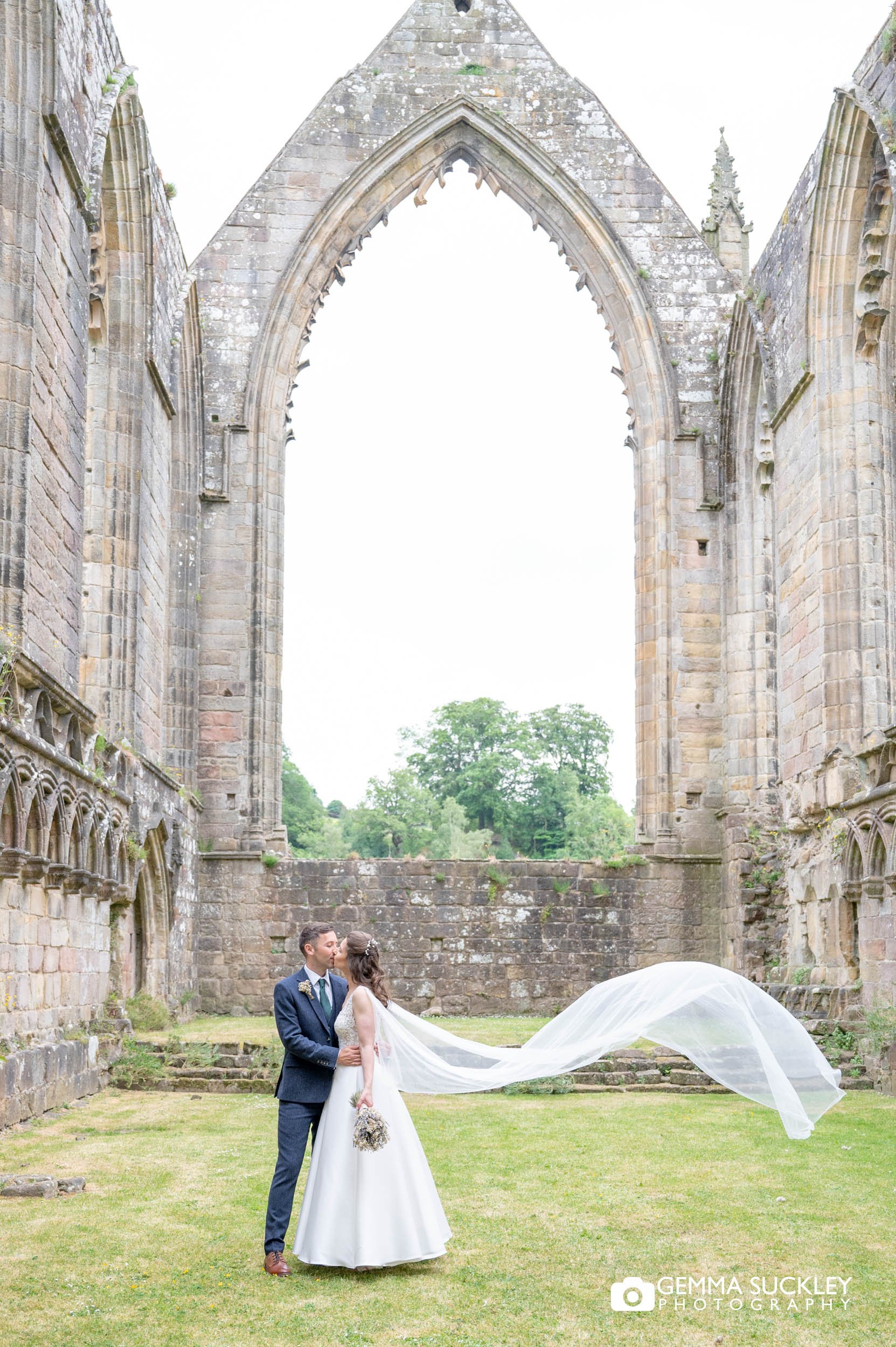 bride and groom at bolton abbey ruins