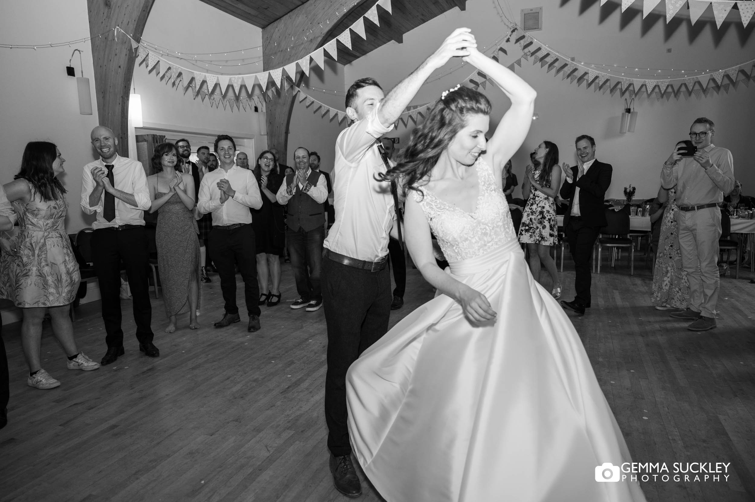 bride and groom dancing at bolton abbey village hall wedding