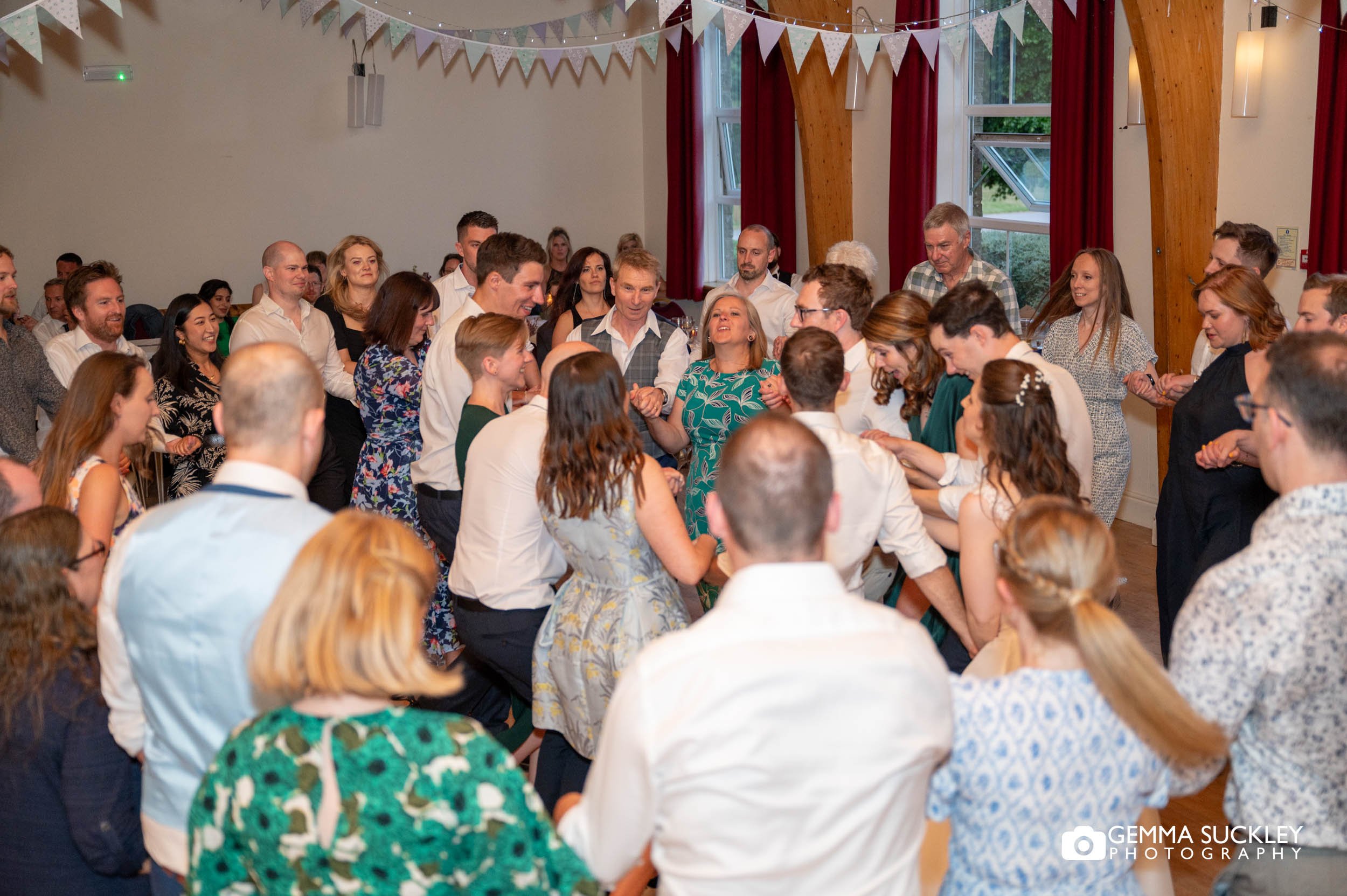 wedding guests at bolton abbey village hall dancing 