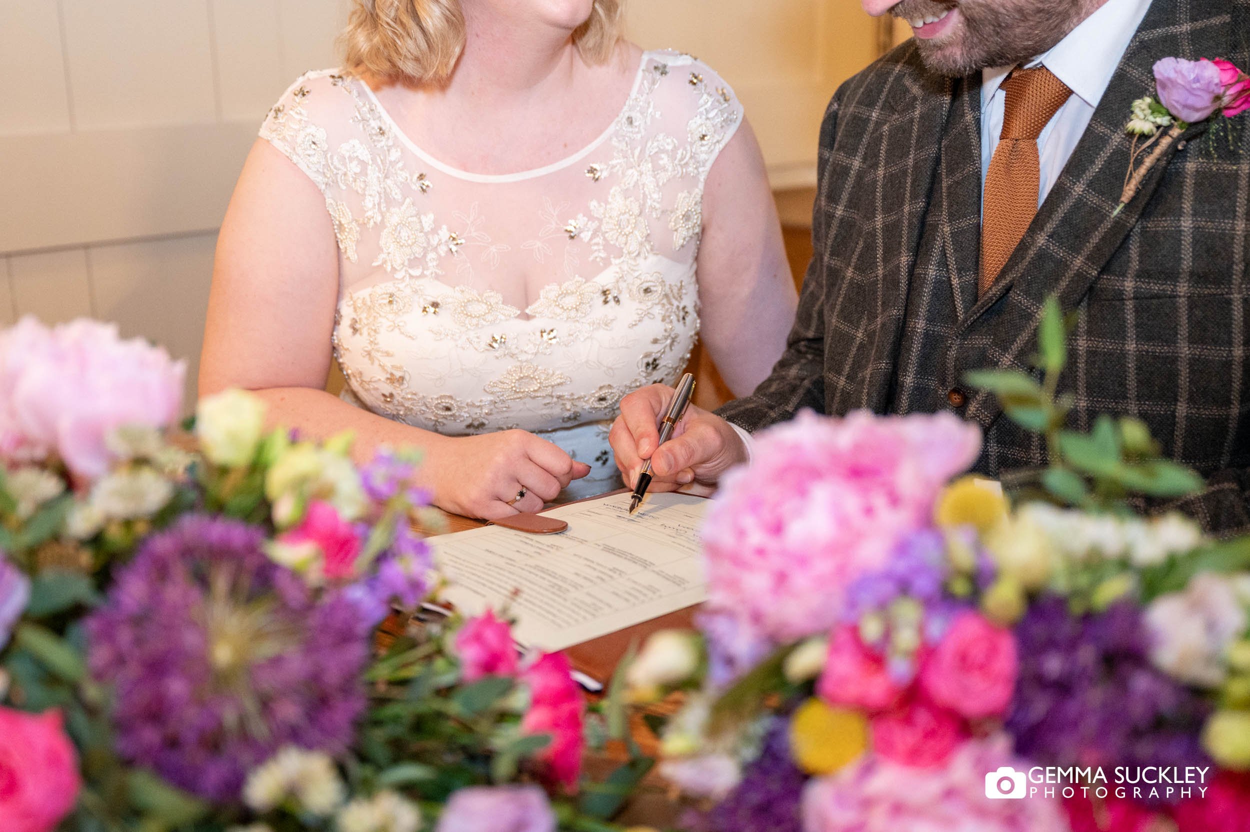 bride signing the register at east riddlesden hall