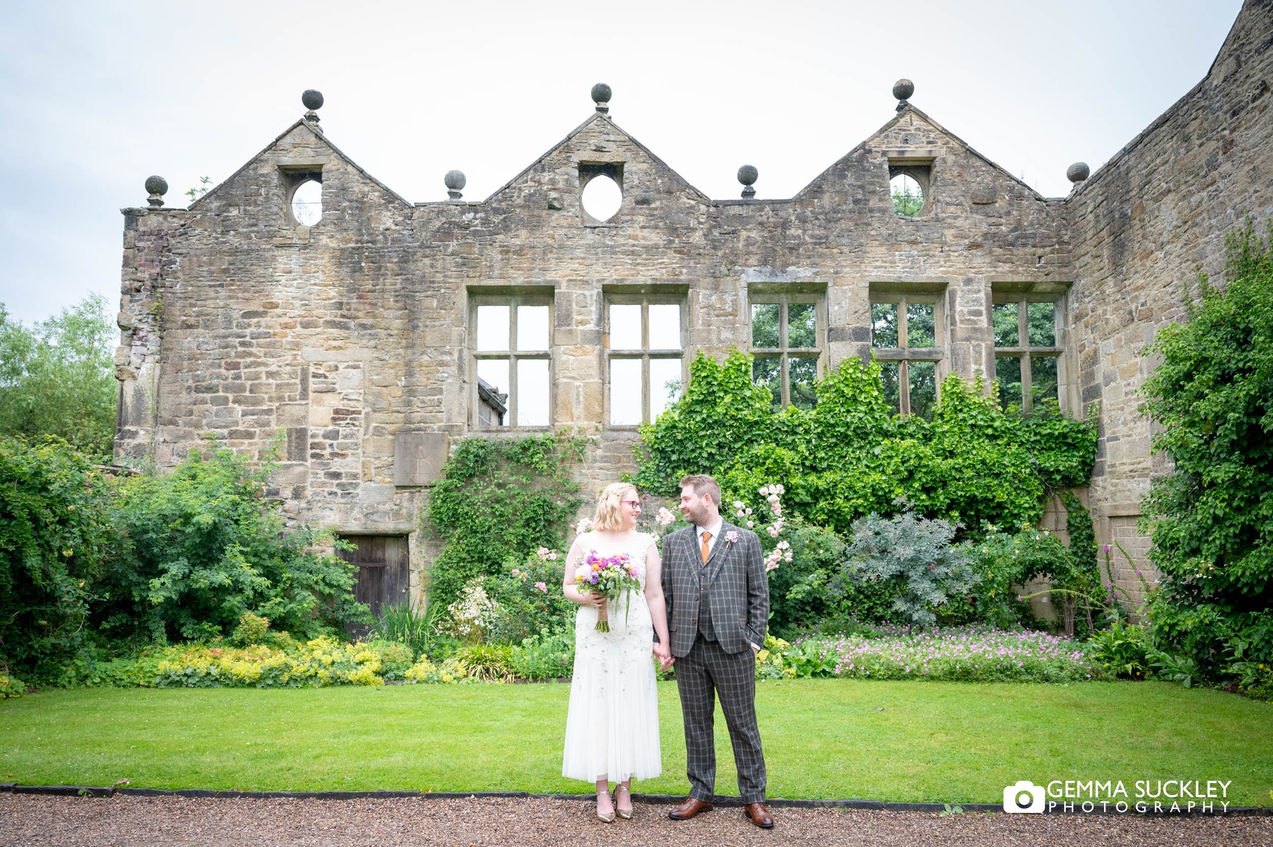 married couple in front of east riddlesden hall