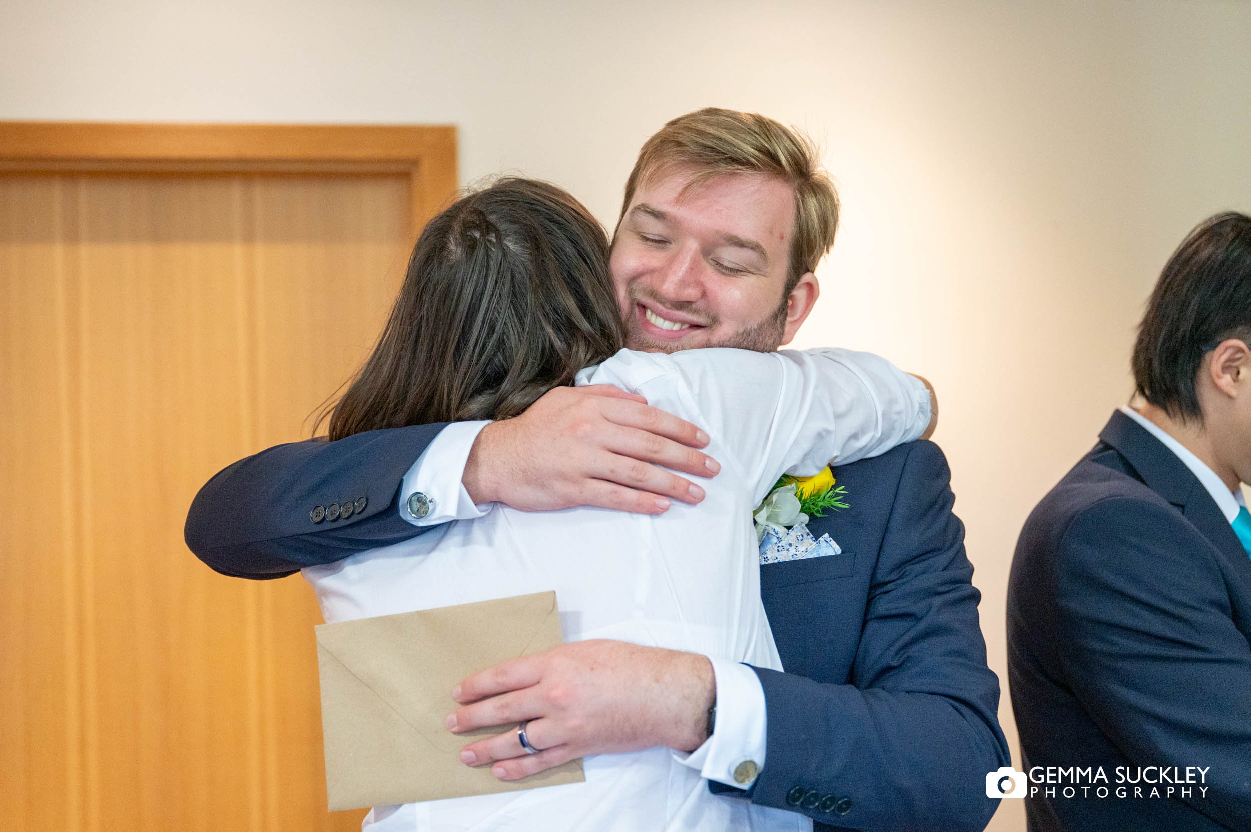 wedding guest hugging the groom at sandburn hall