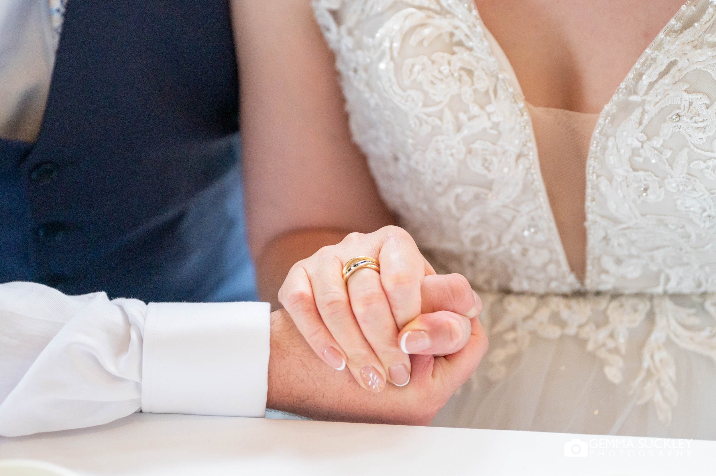 bride and groom holding hands