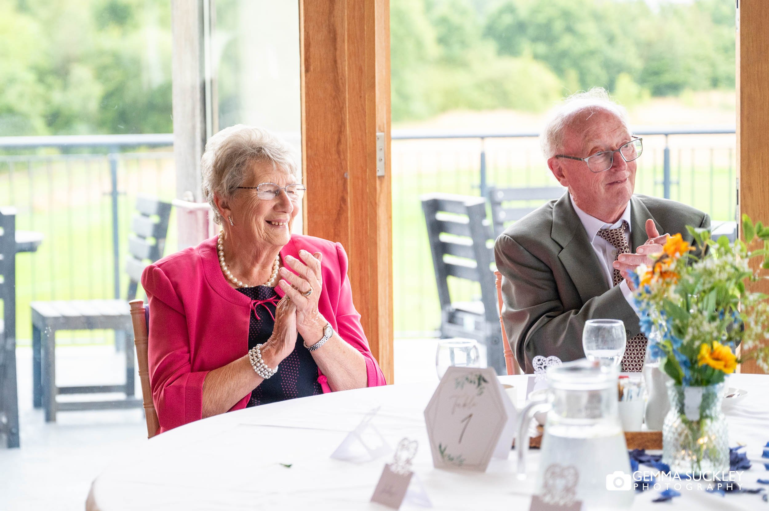 wedding guest clapping at speeches at sandburn hall