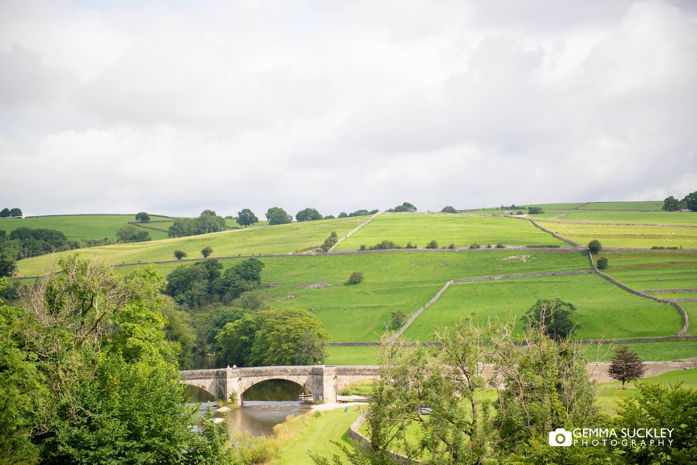 a view of Burnsall's bridge and the river whafe