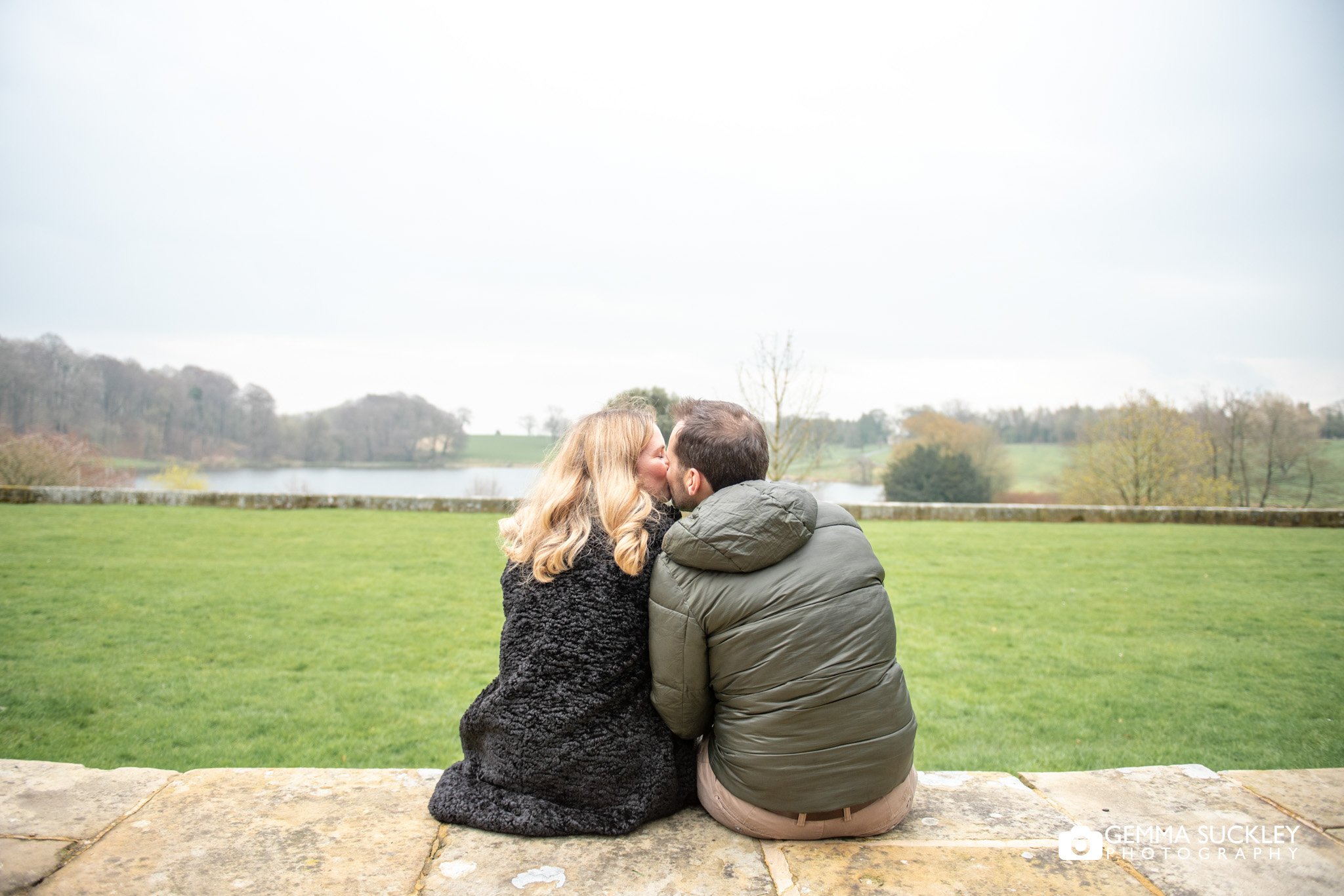 engaged couple kissing at coniston lake