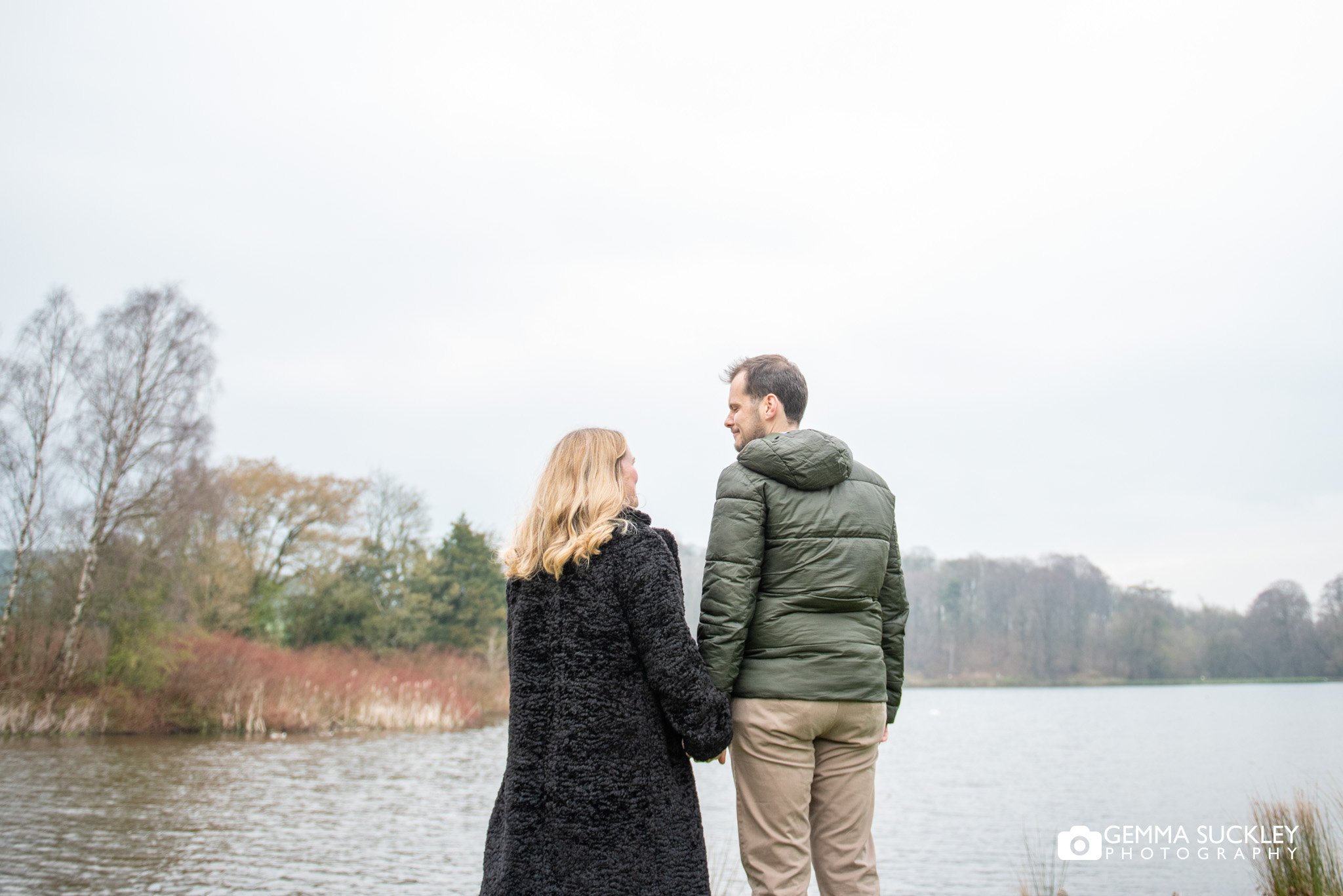 engaged couple looking out at the coniston lake pre wedding