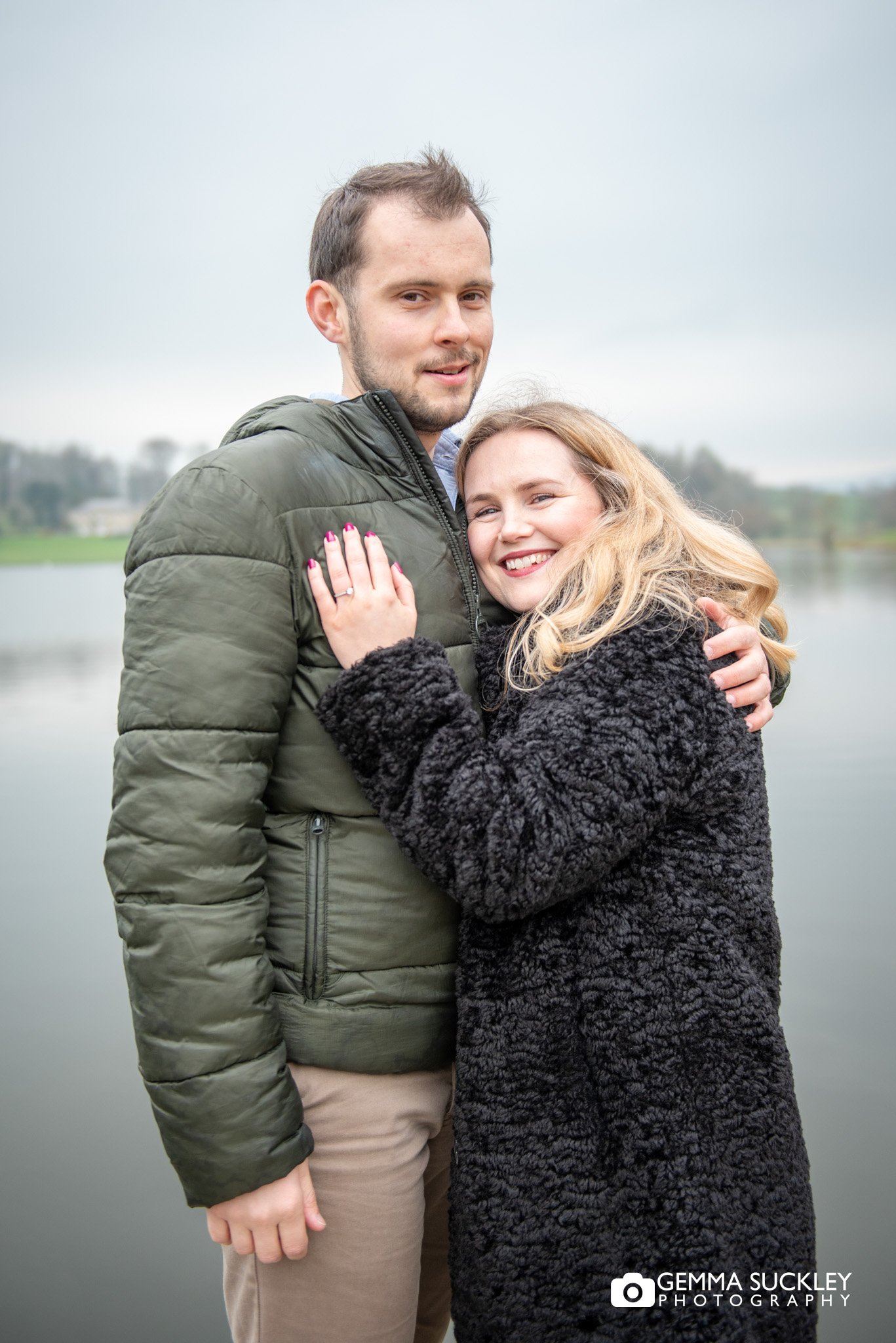 engaged couple laughing together at consiton lake in skipton