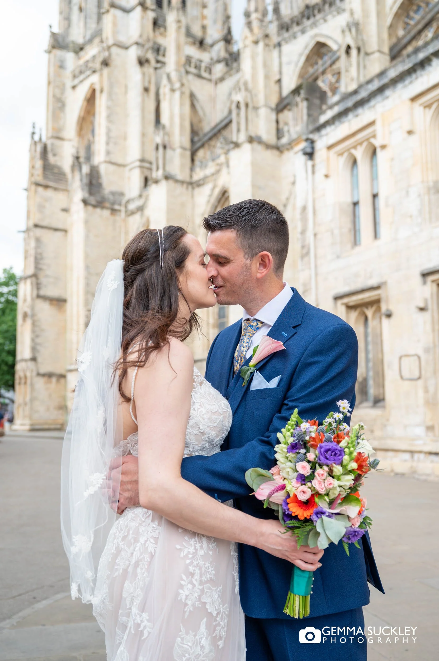 newly-weds kissing in front of york minster
