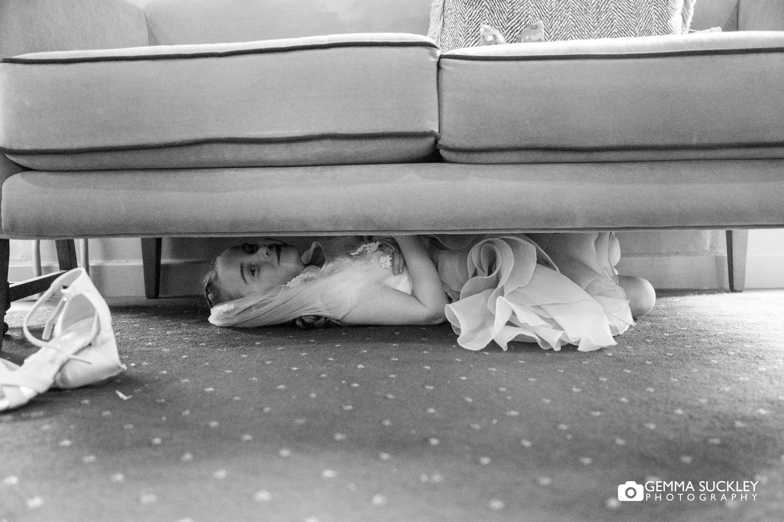 flower girl hiding under a chair