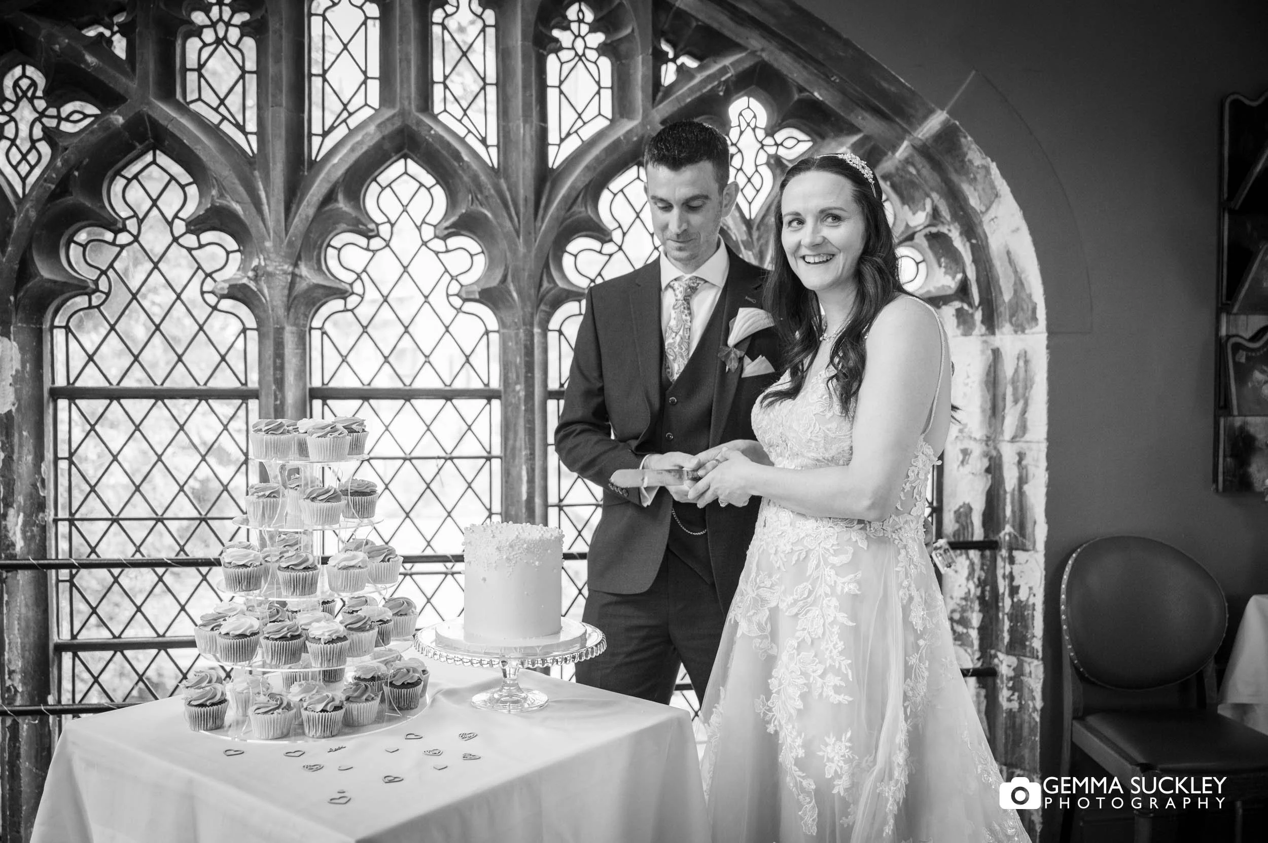 bride cutting the cake at york minster refectory