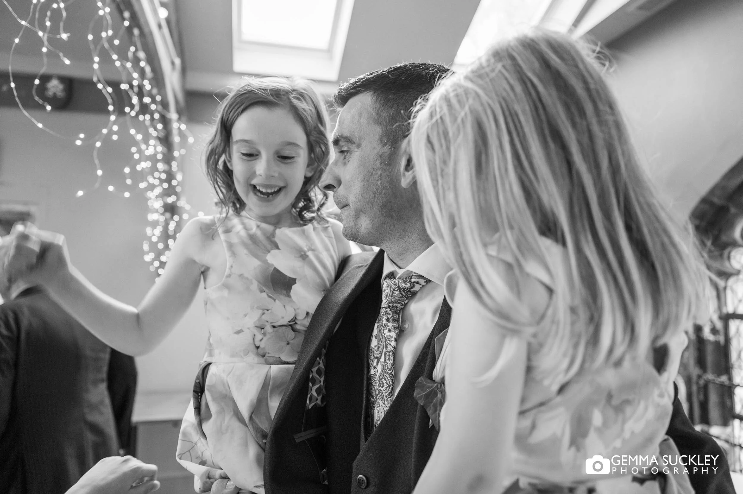 groom hugging his nieces at the wedding reception