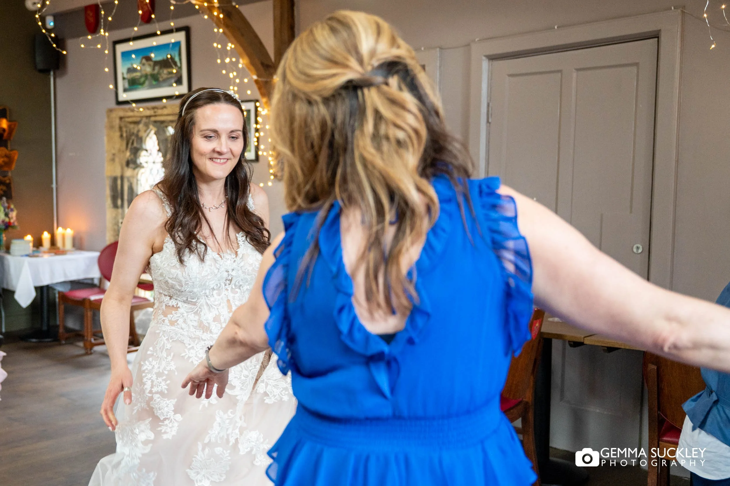 bride and bridesmaid dancing at york minster refectory