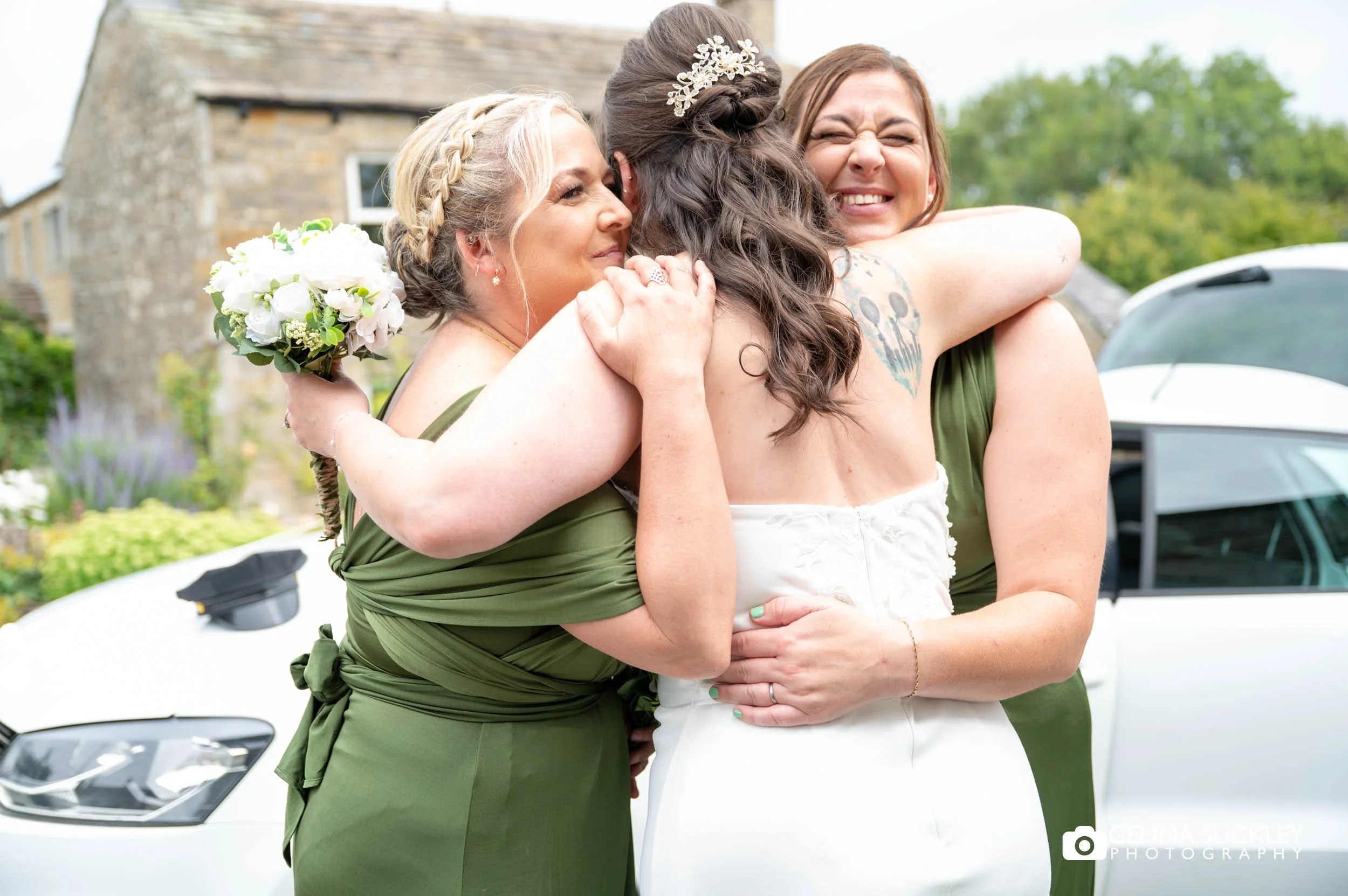 bride hugging her bridesmaids