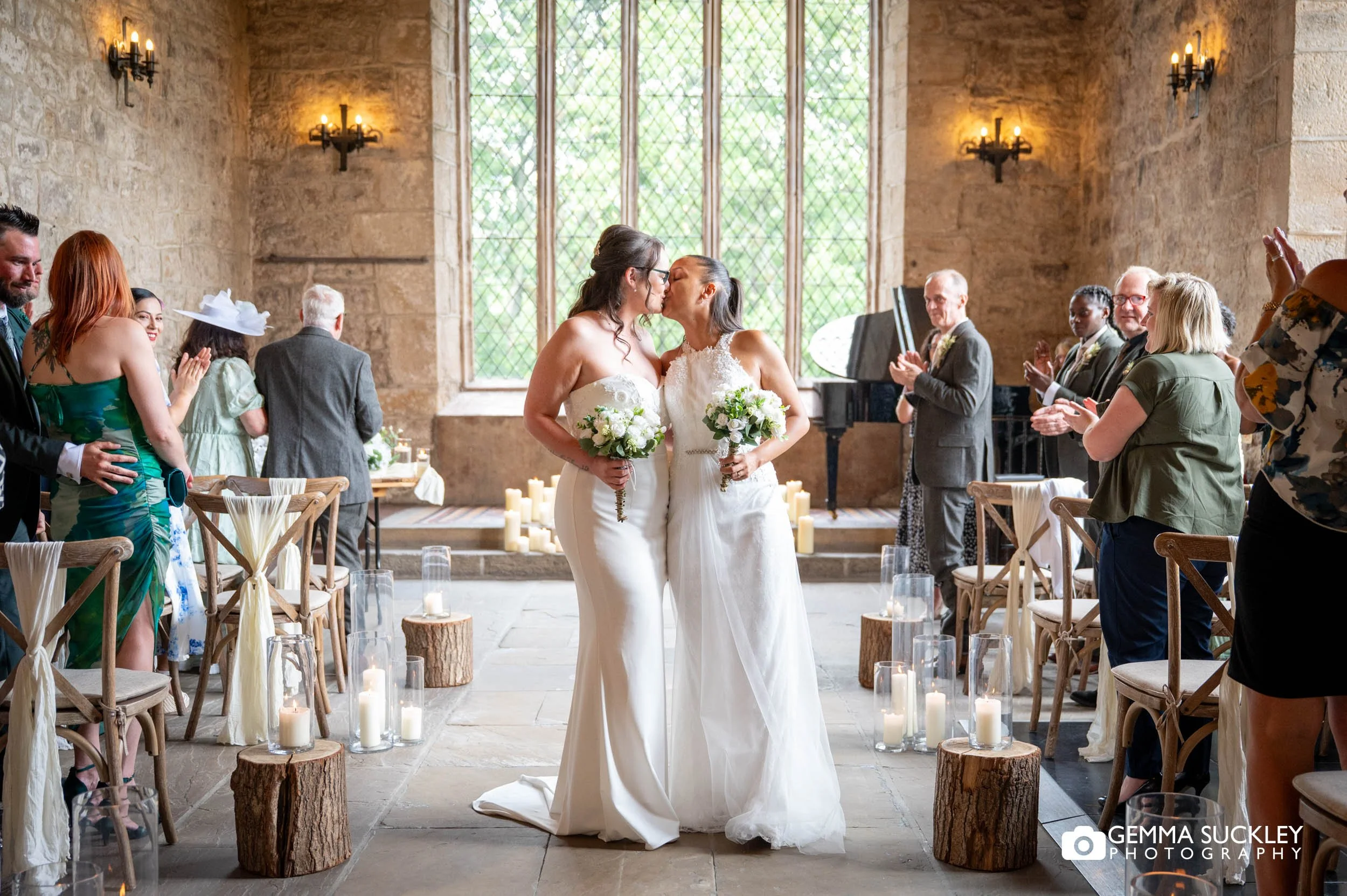 newly-weds kiss as they exit the priests house