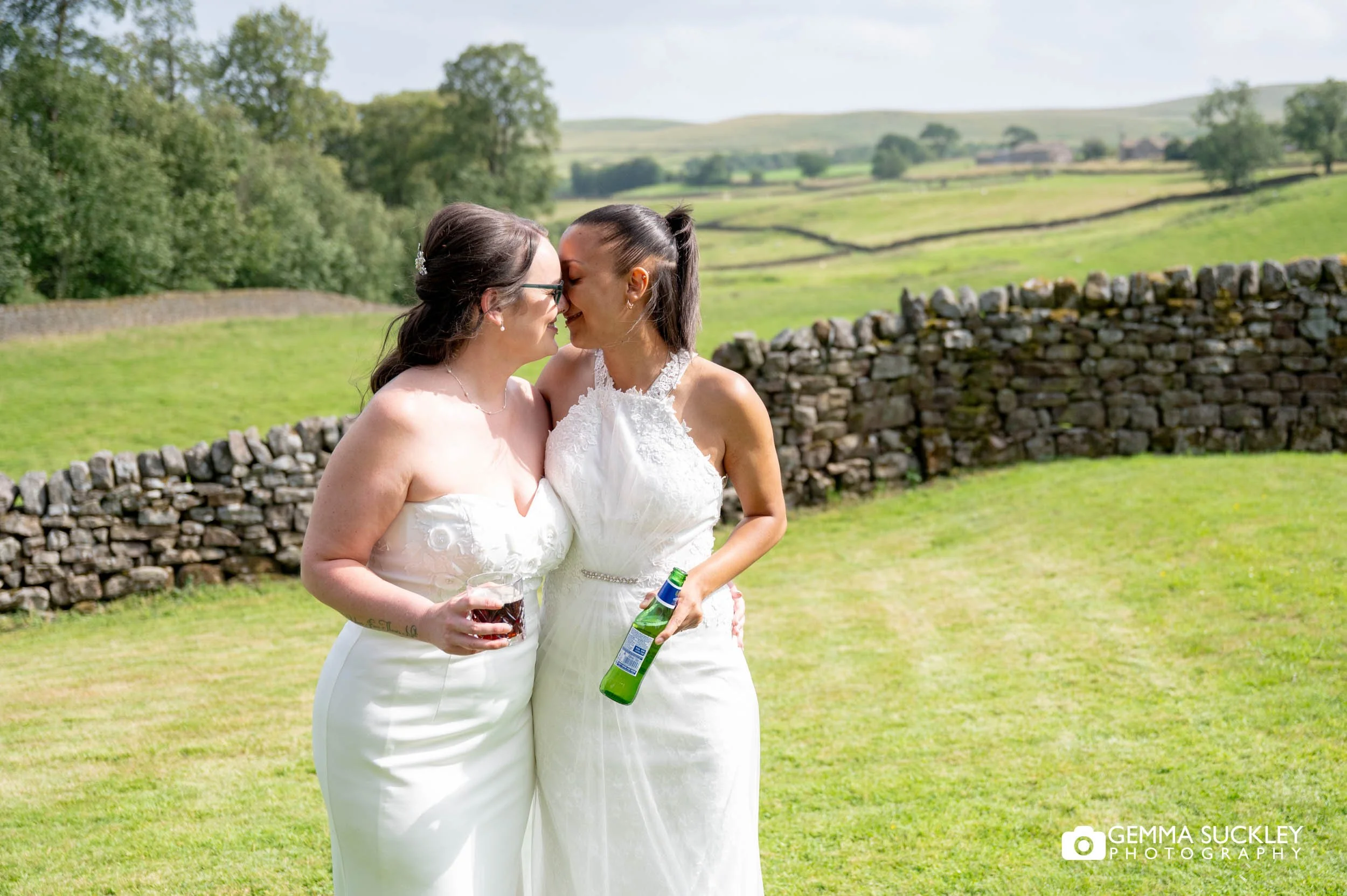 newly-weds kiss outside the priests house at barden tower