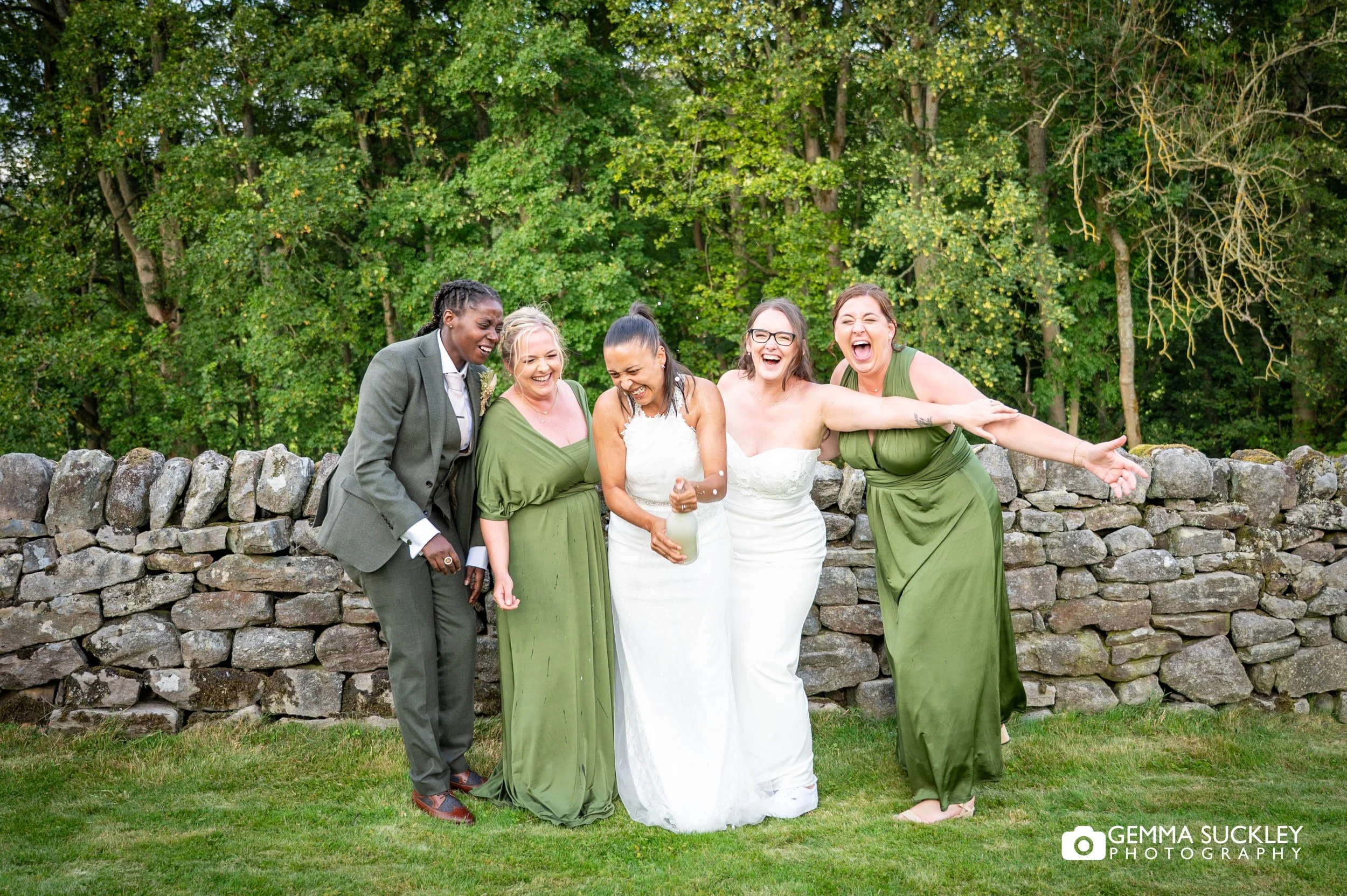 bridal party laughing after spraying champange