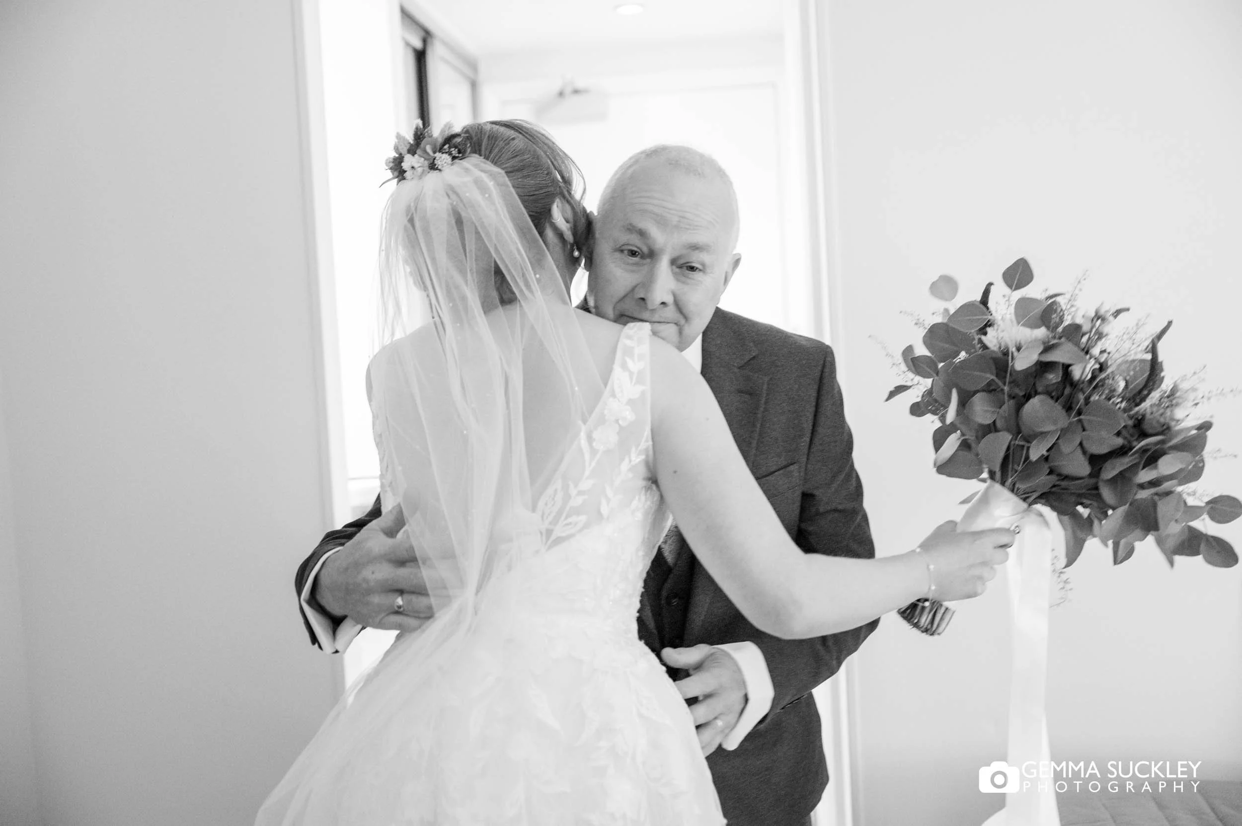 father of the bride hugging his daughter