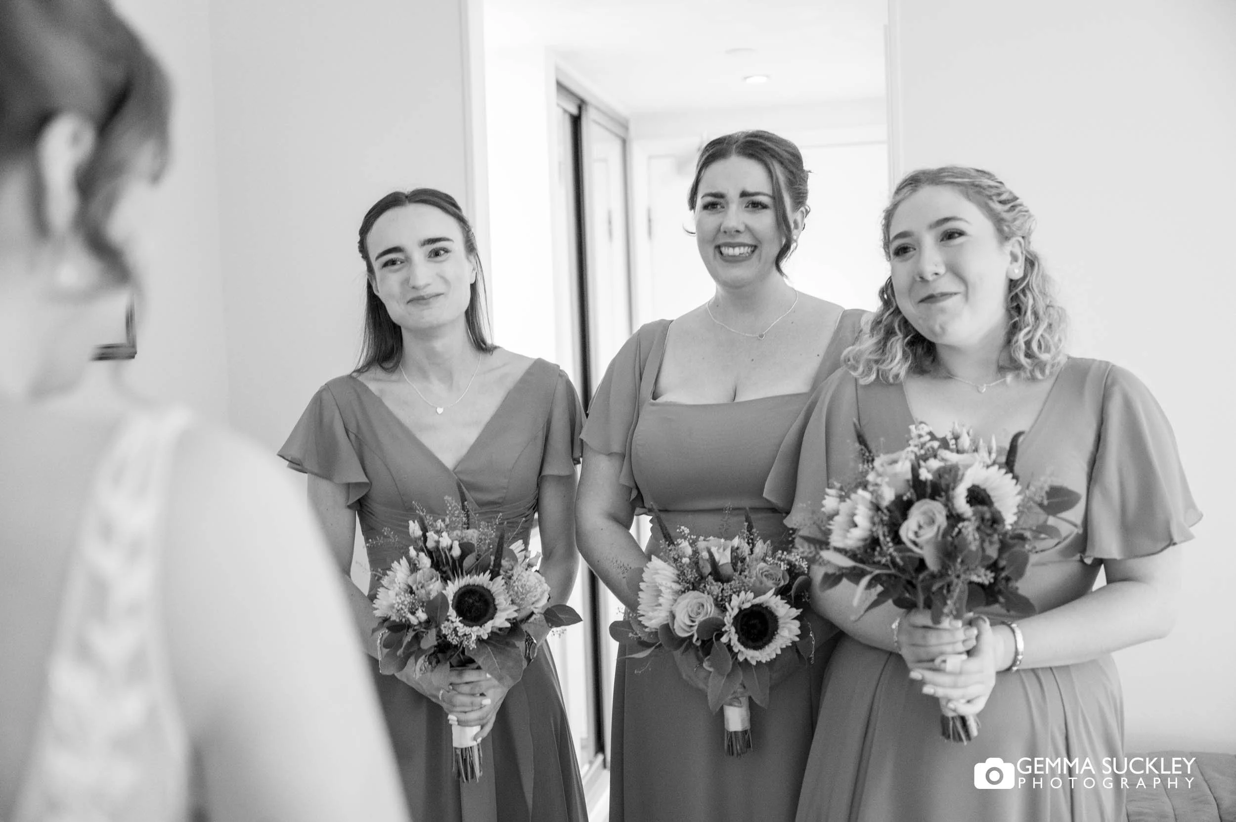 bridesmaids first look of the bride in her dress