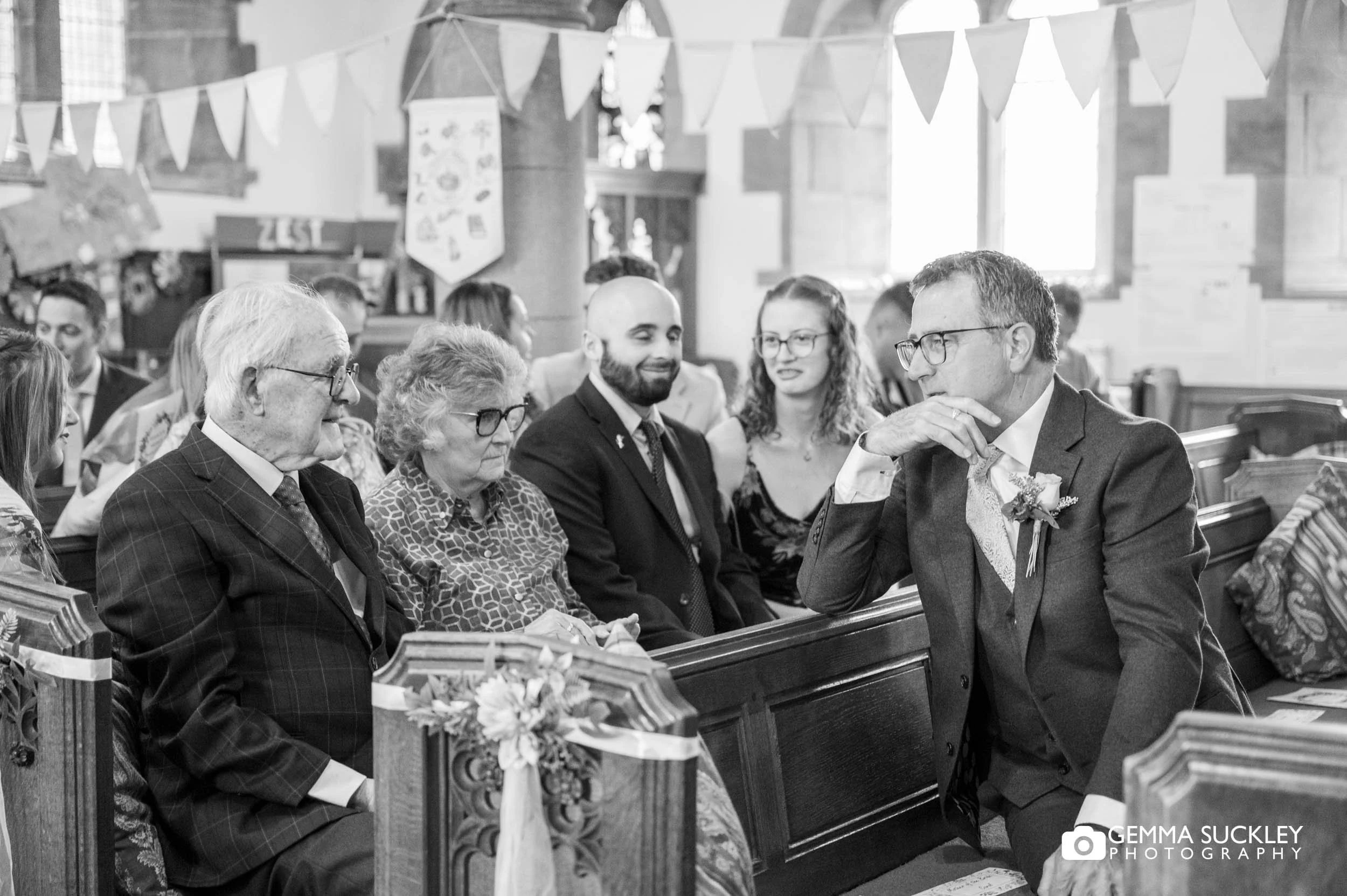 wedding guests in church pre wedding ceremony