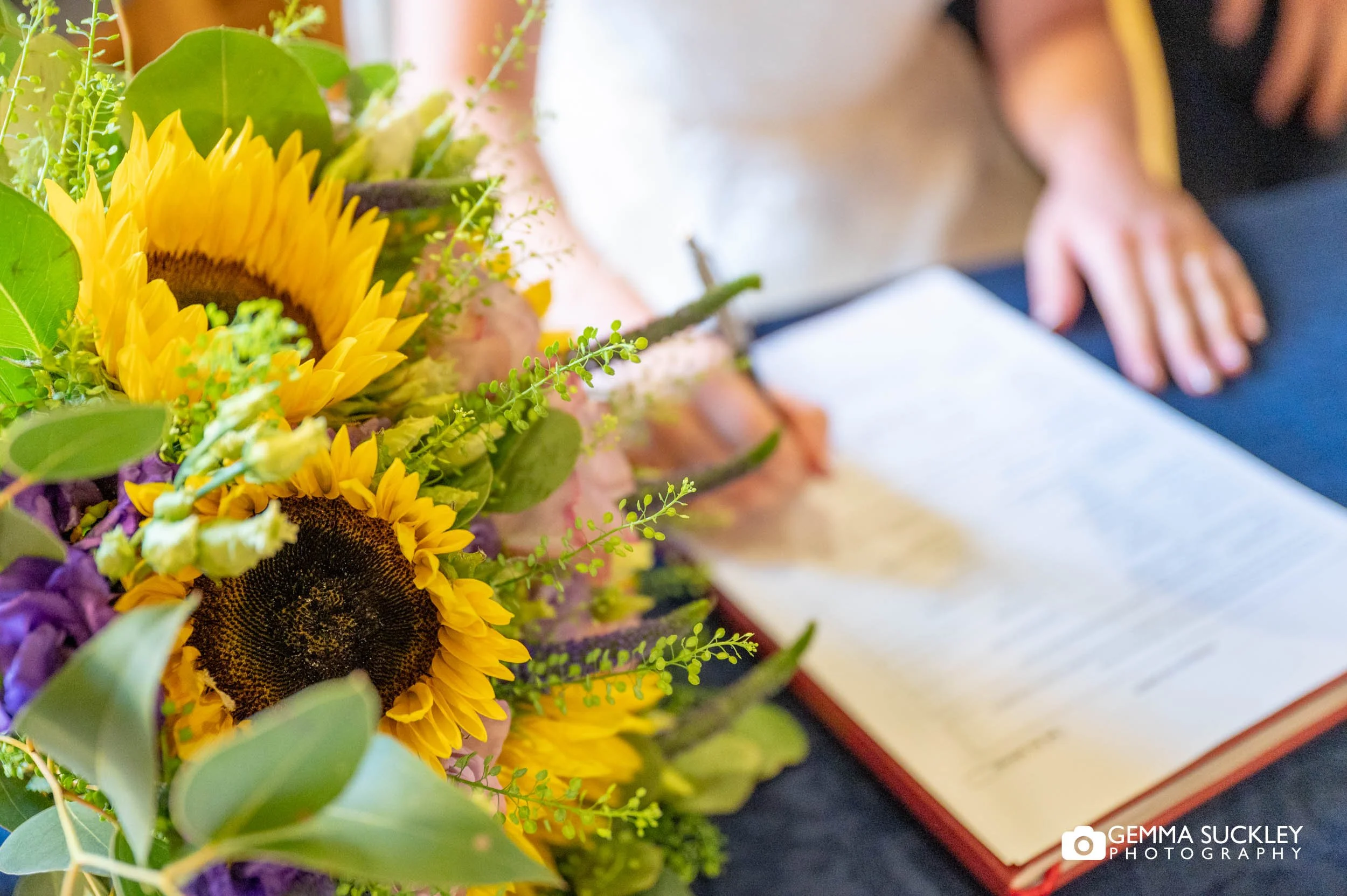 bride and groom signing the register