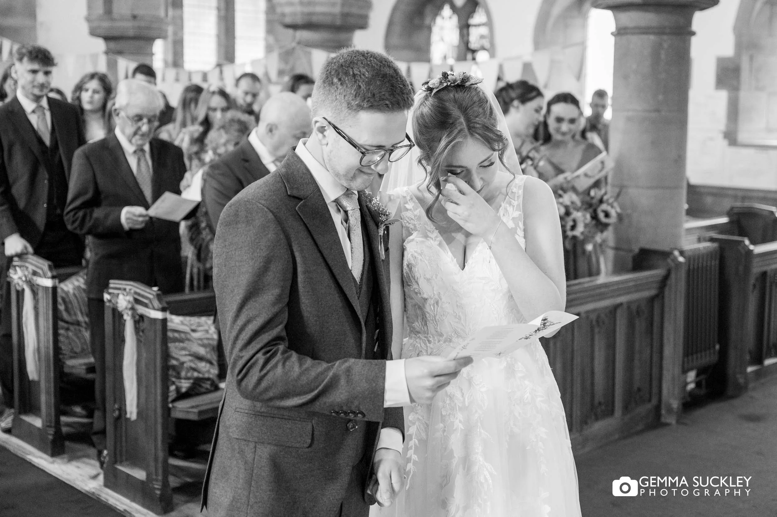 bride sheds a tear as they sing a hymn