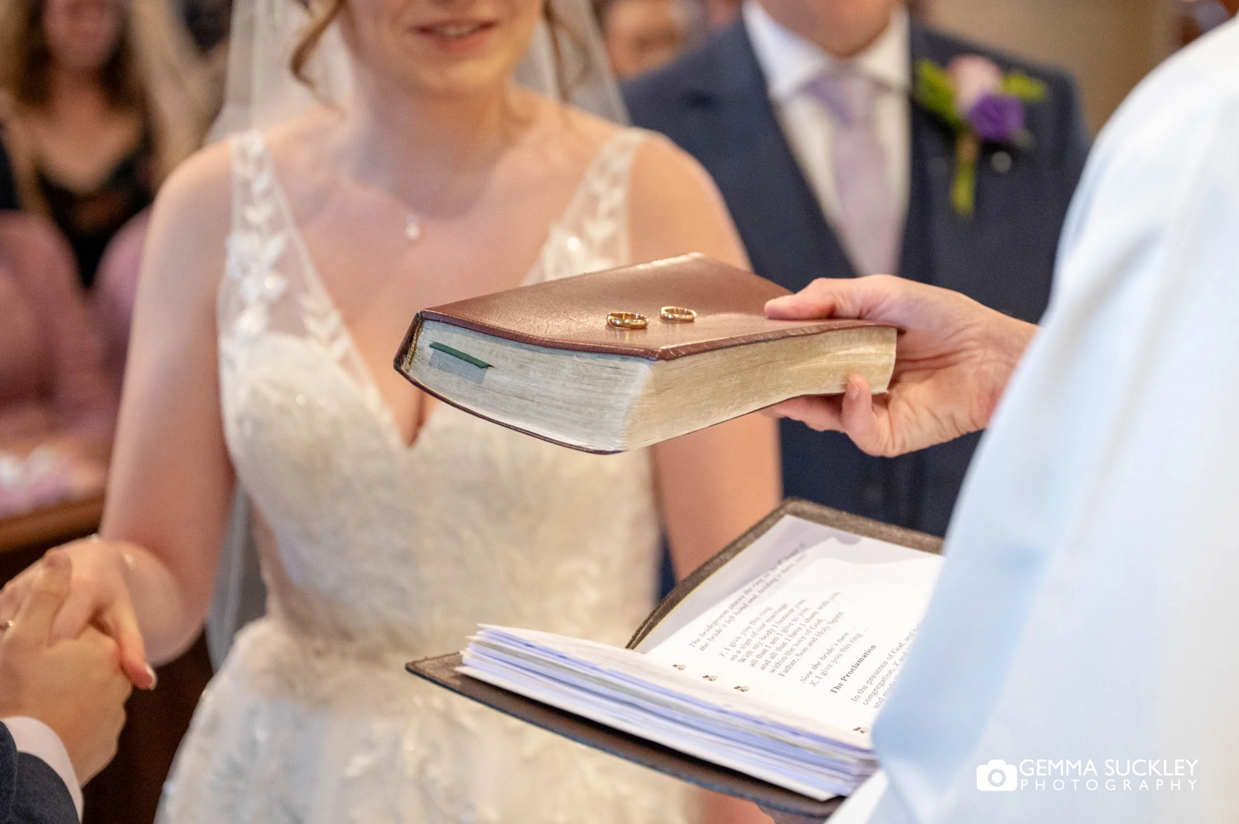 the priest holding up the wedding rings