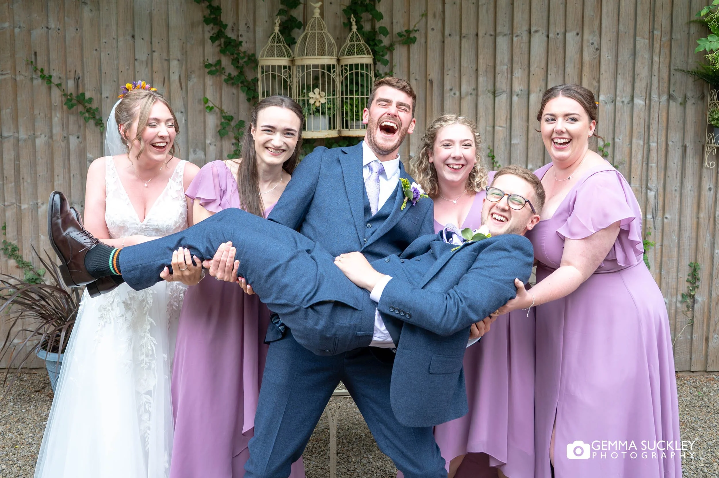 the bridal and grooms party picking up the groom