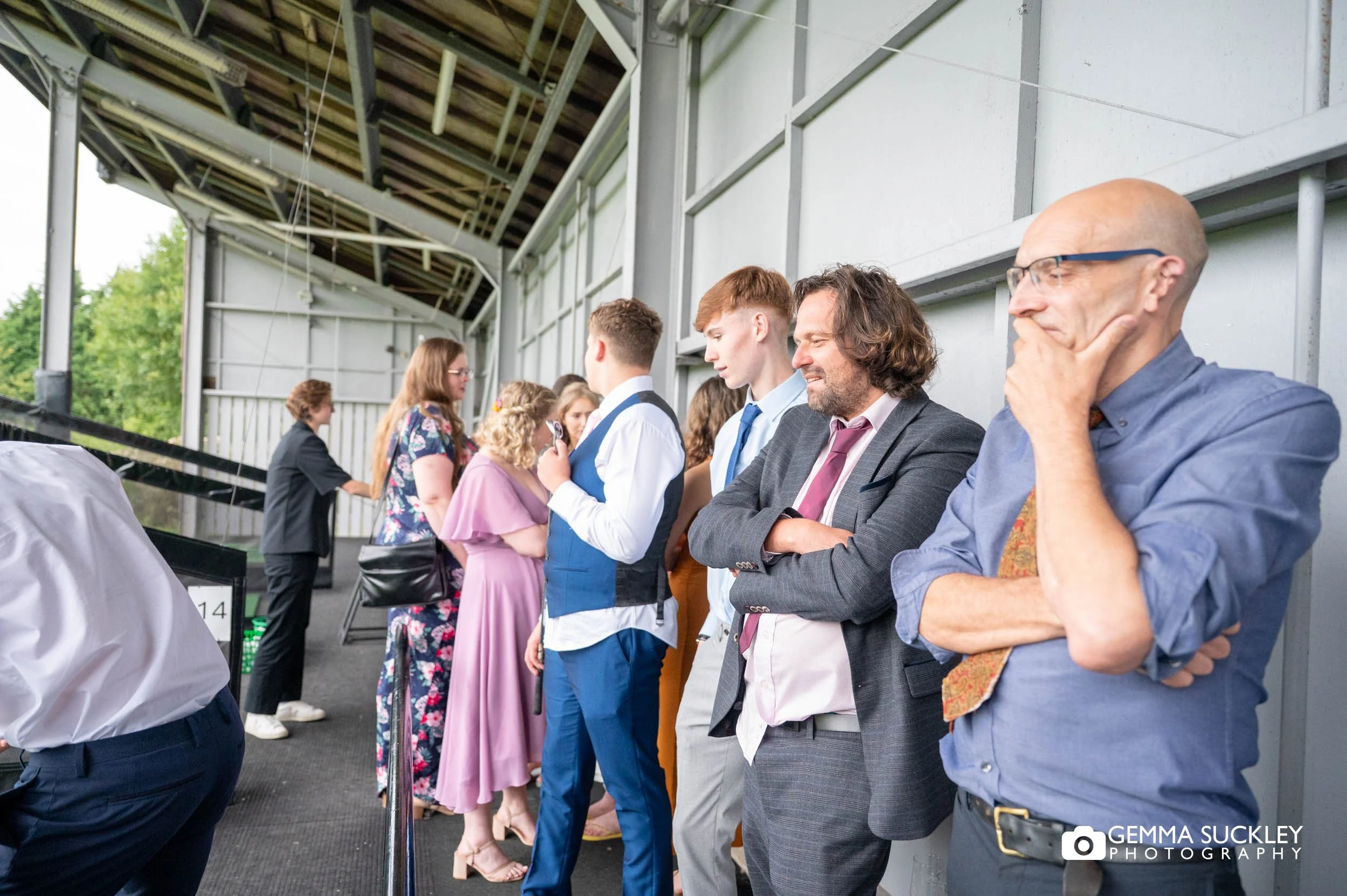 wedding guests at driving range at the old barn in esholt