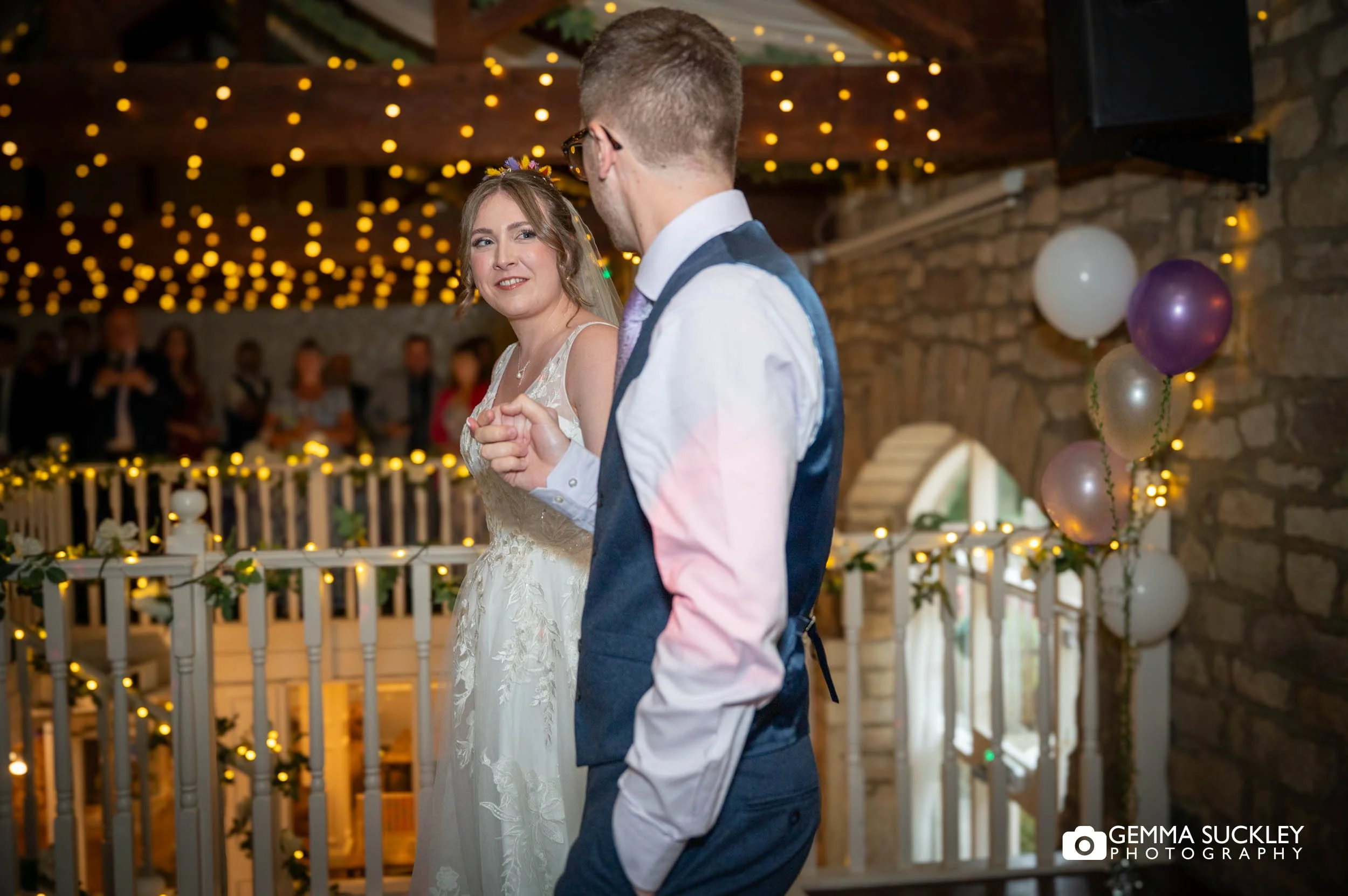 newly-weds walking to the dancefloor at the old barn