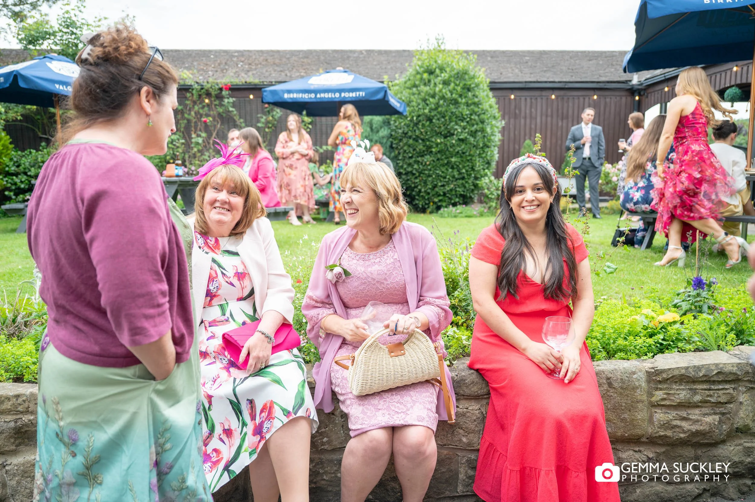 wedding guests in the garden at the old barn in esholts