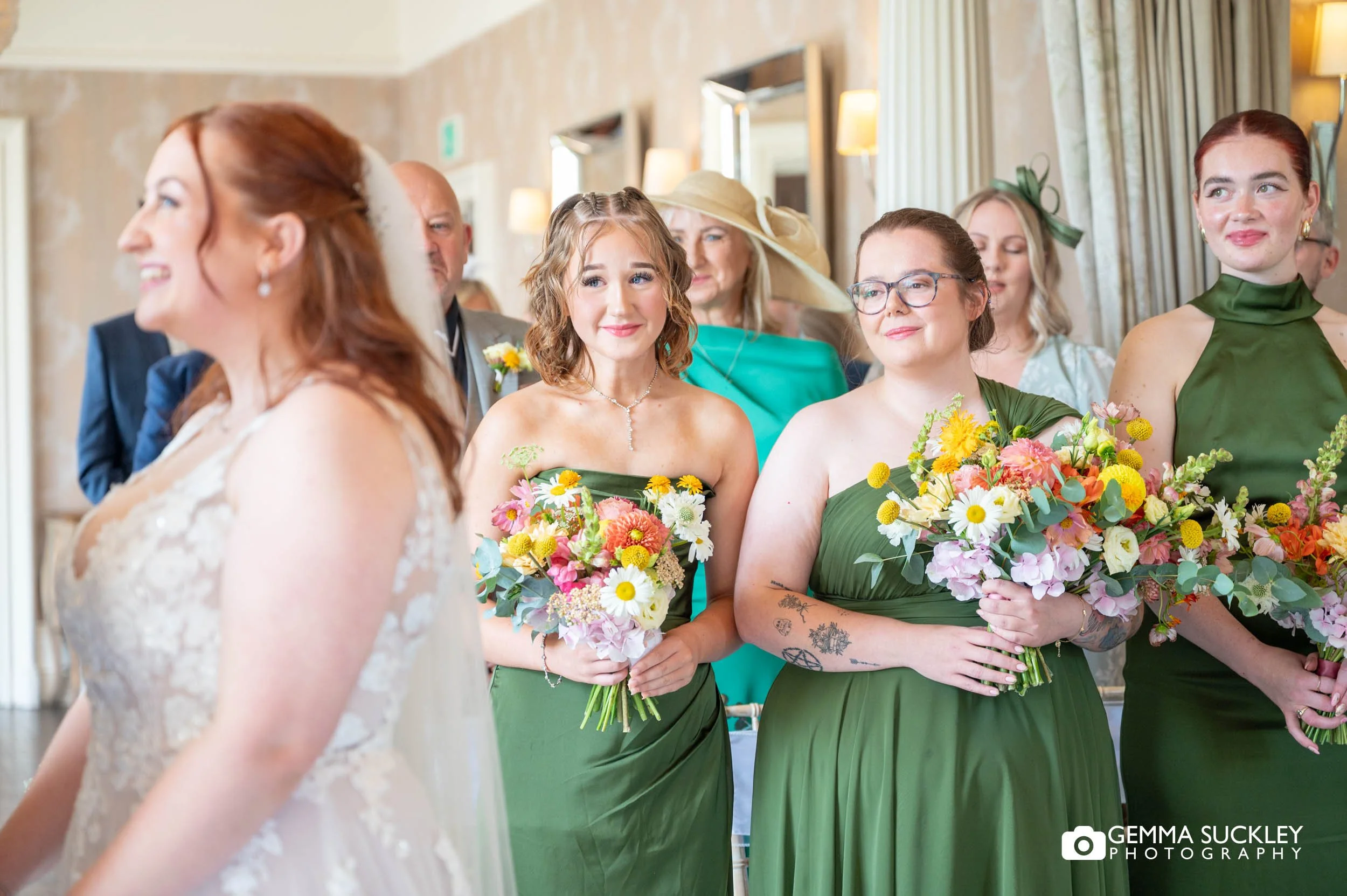 bridesmaids shedding a tear at the wedding ceremony