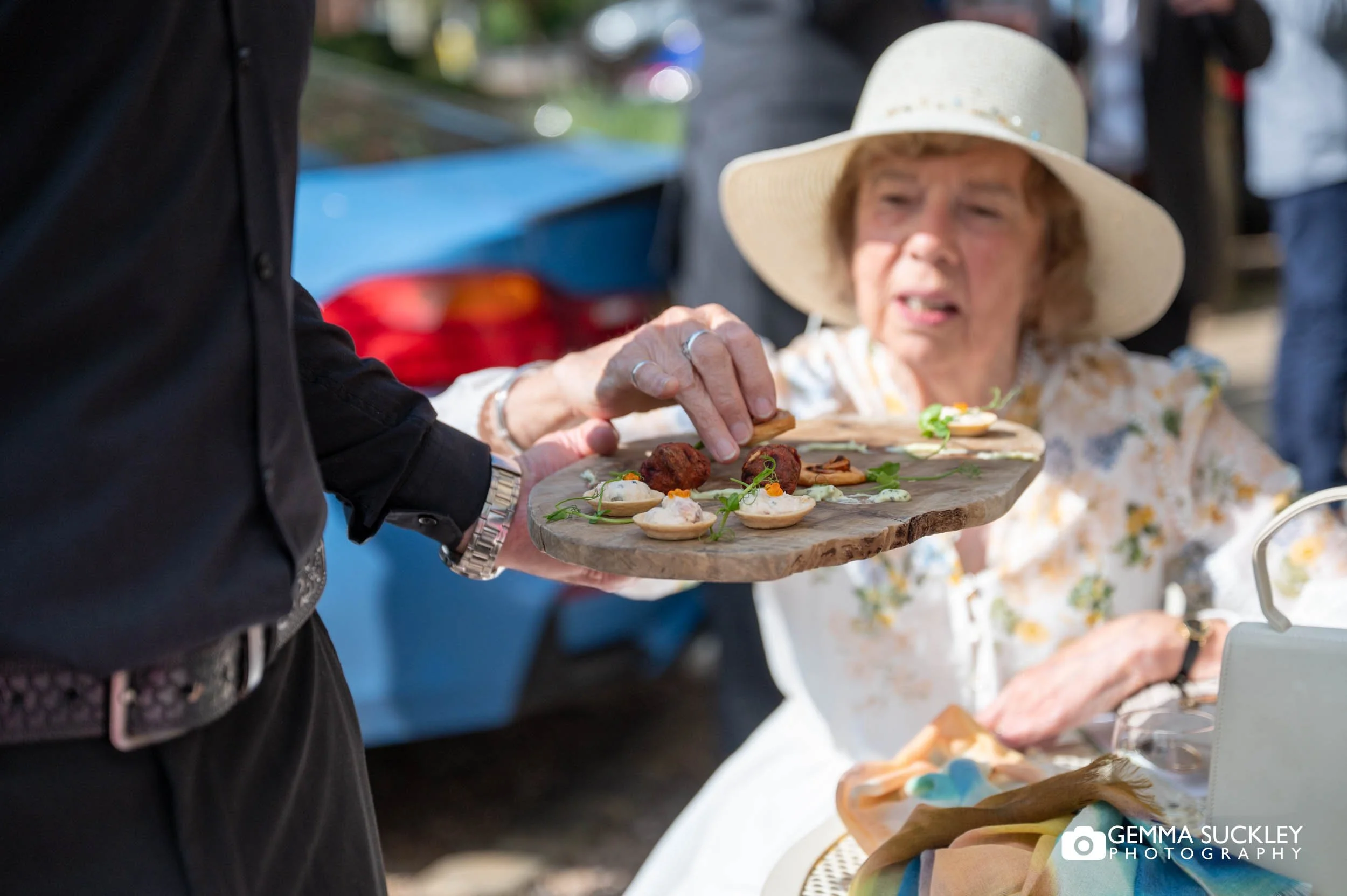 wedding guest eating a canapé