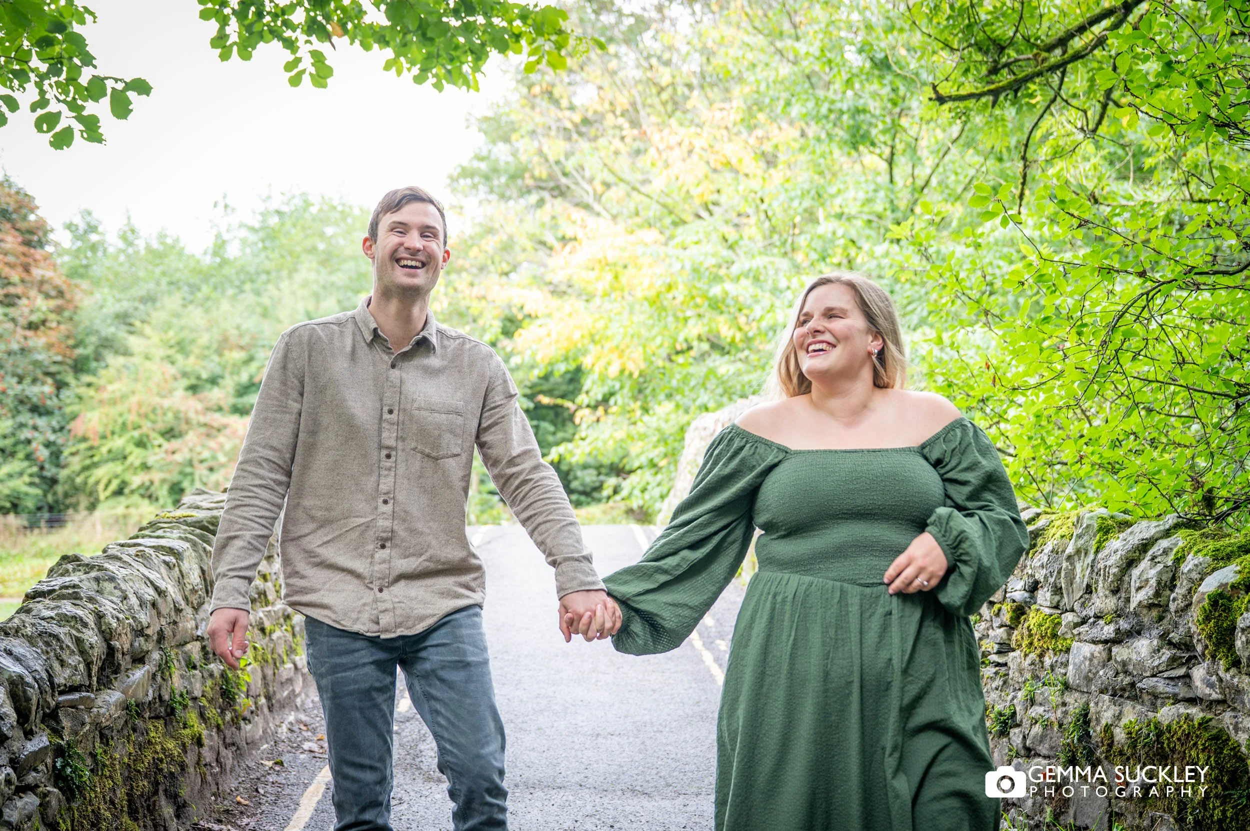 engaged couple walking over the bridge at stainforth force