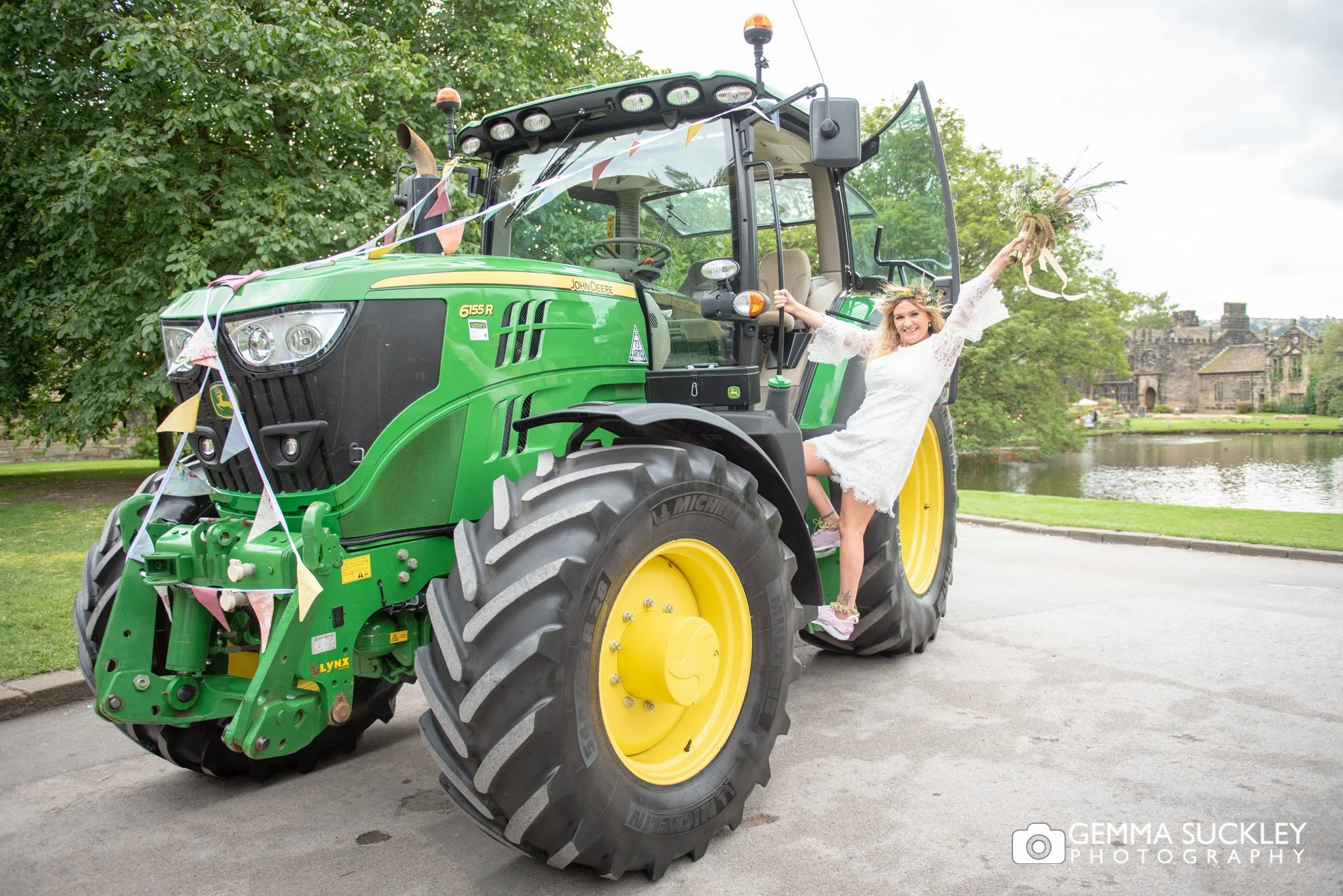 alternative bride hanging off a tractor at east riddlesden hall