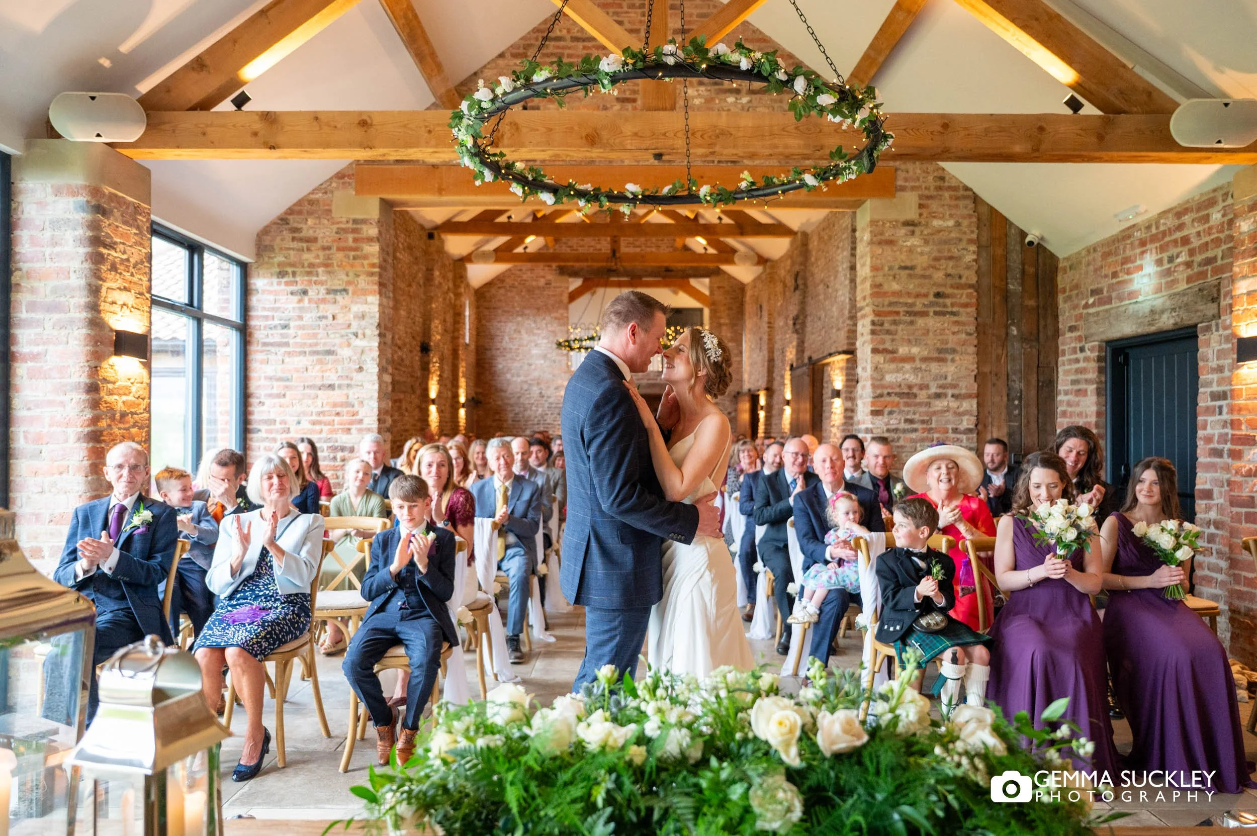 bride and groom kiss at thrisk lodge barn wedding ceremony