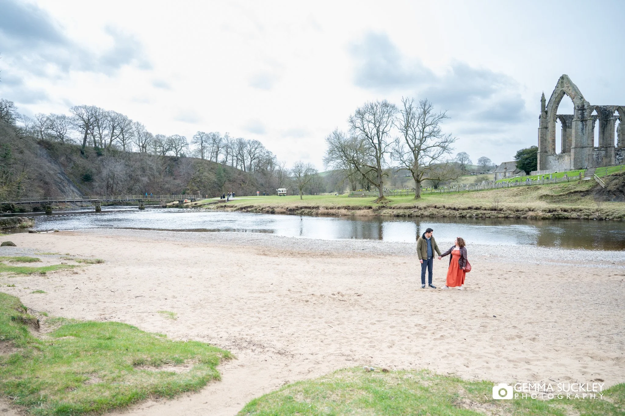 engaged couple on the beach at bolton abbey