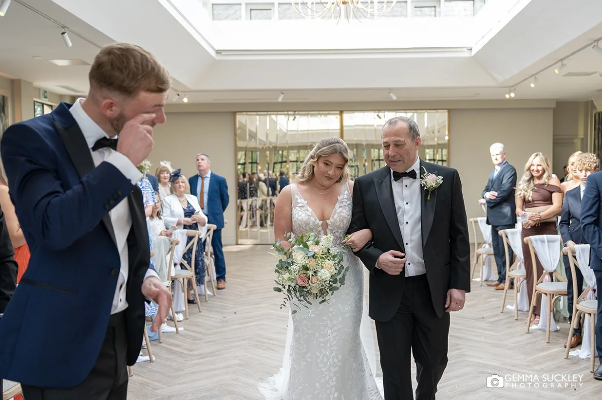 the groom wiping away a tear at woodlands hotel wedding ceremony