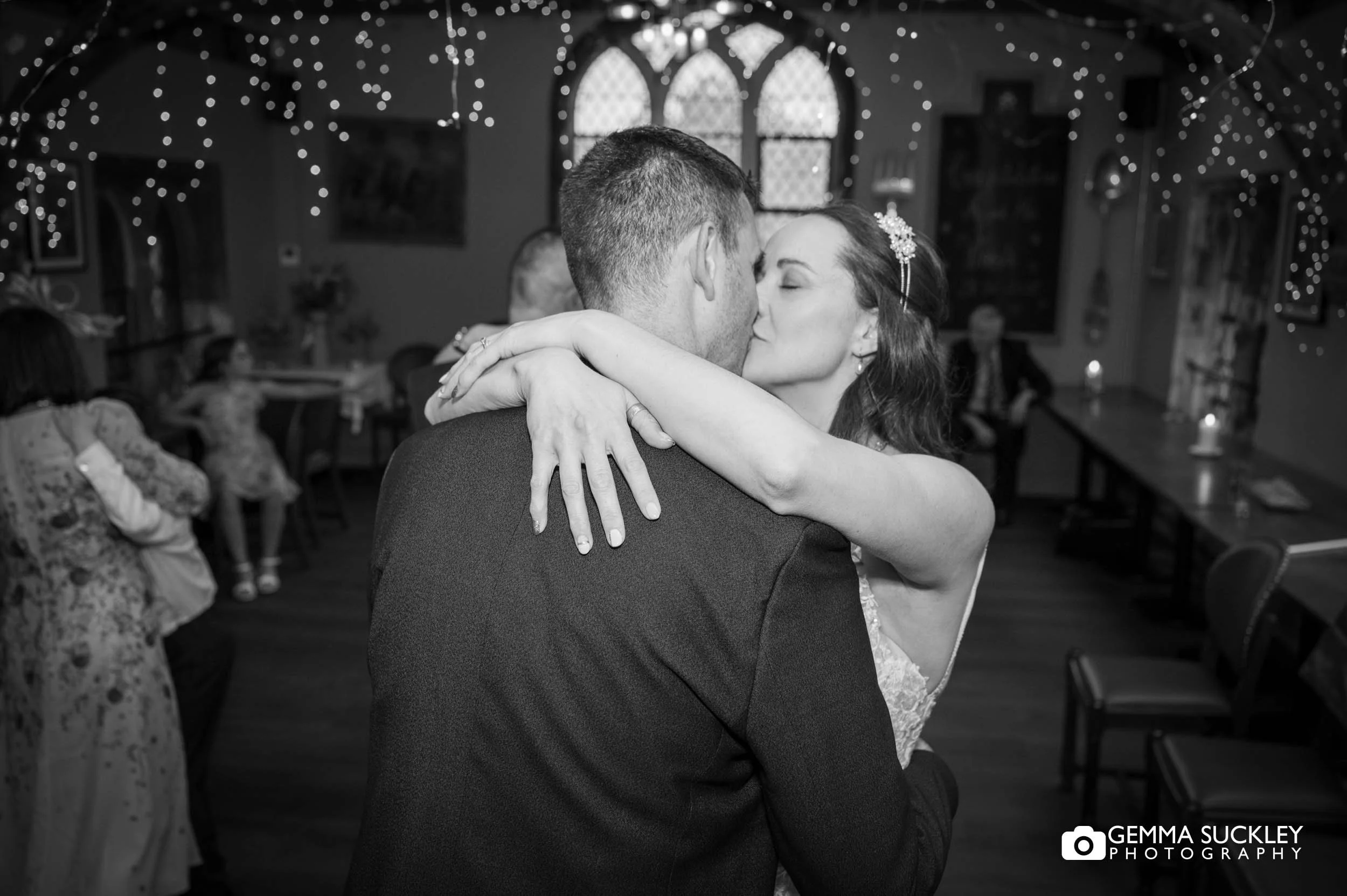 bride and groom kissing on the dance floor
