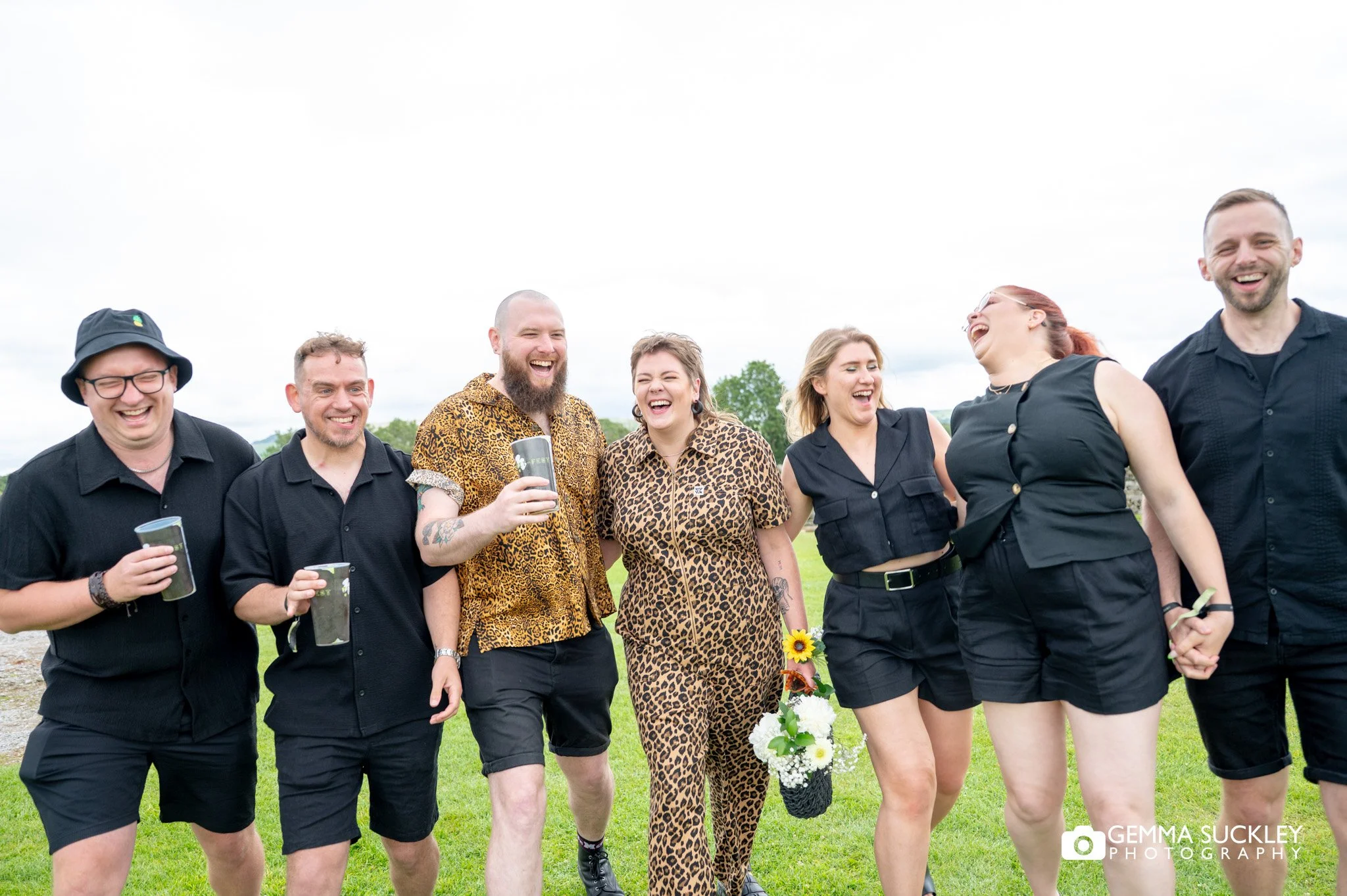 groom ands bridal party linking and laughing