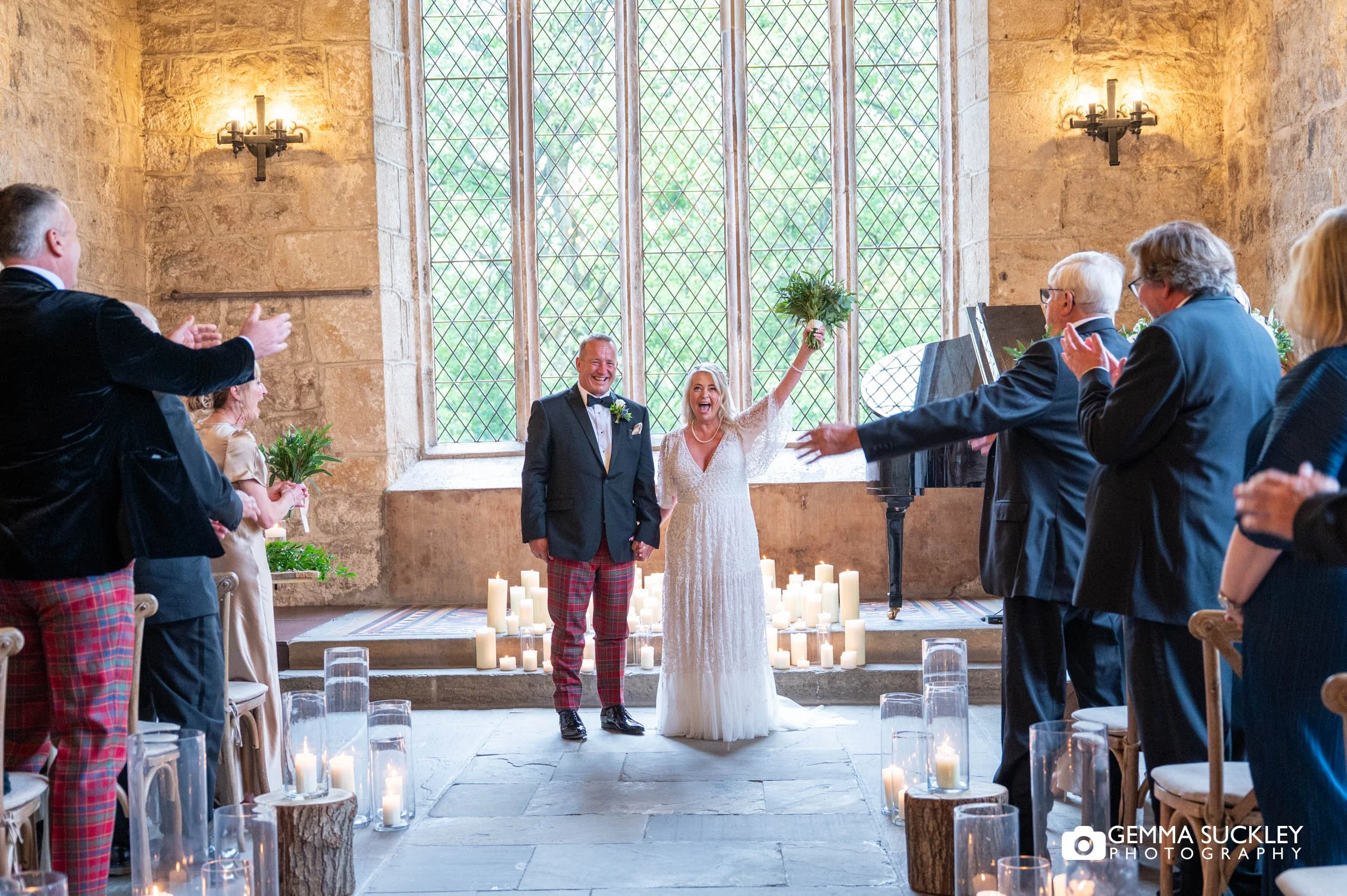 groom and bride with flowers in the air at the priests house