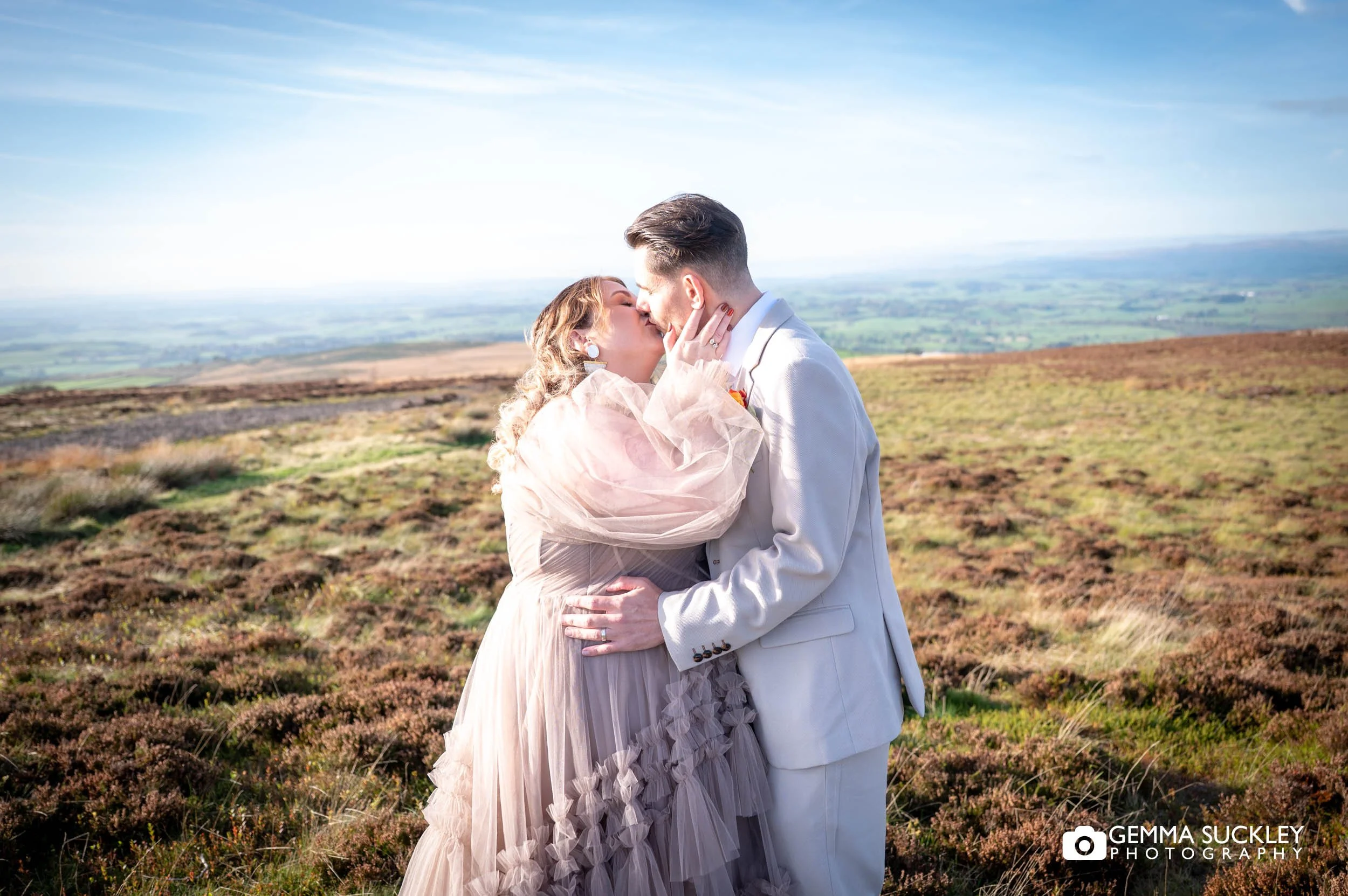 just married couple kissing on eslack moors