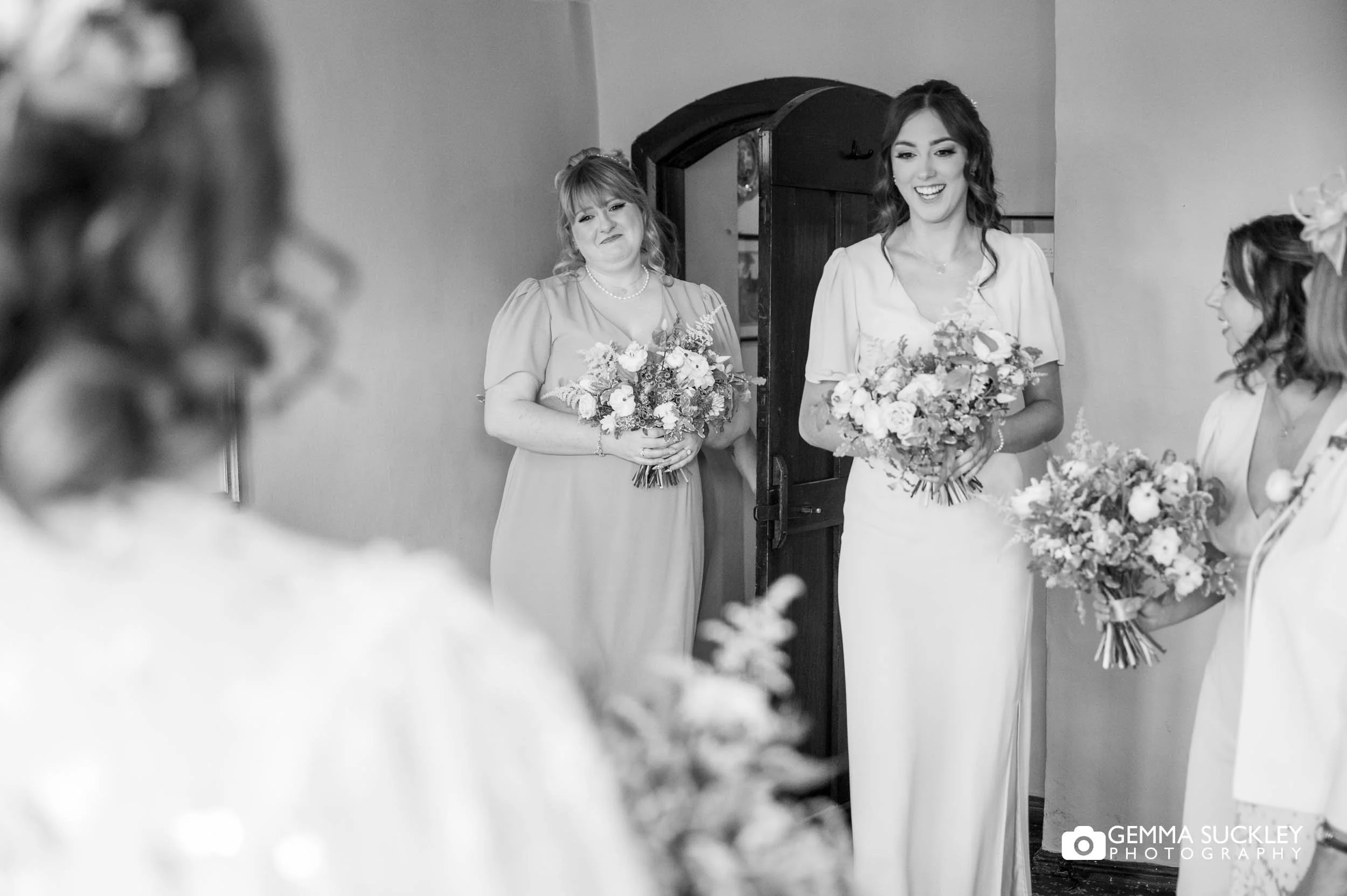 bridesmaids reaction to the bride in her dress