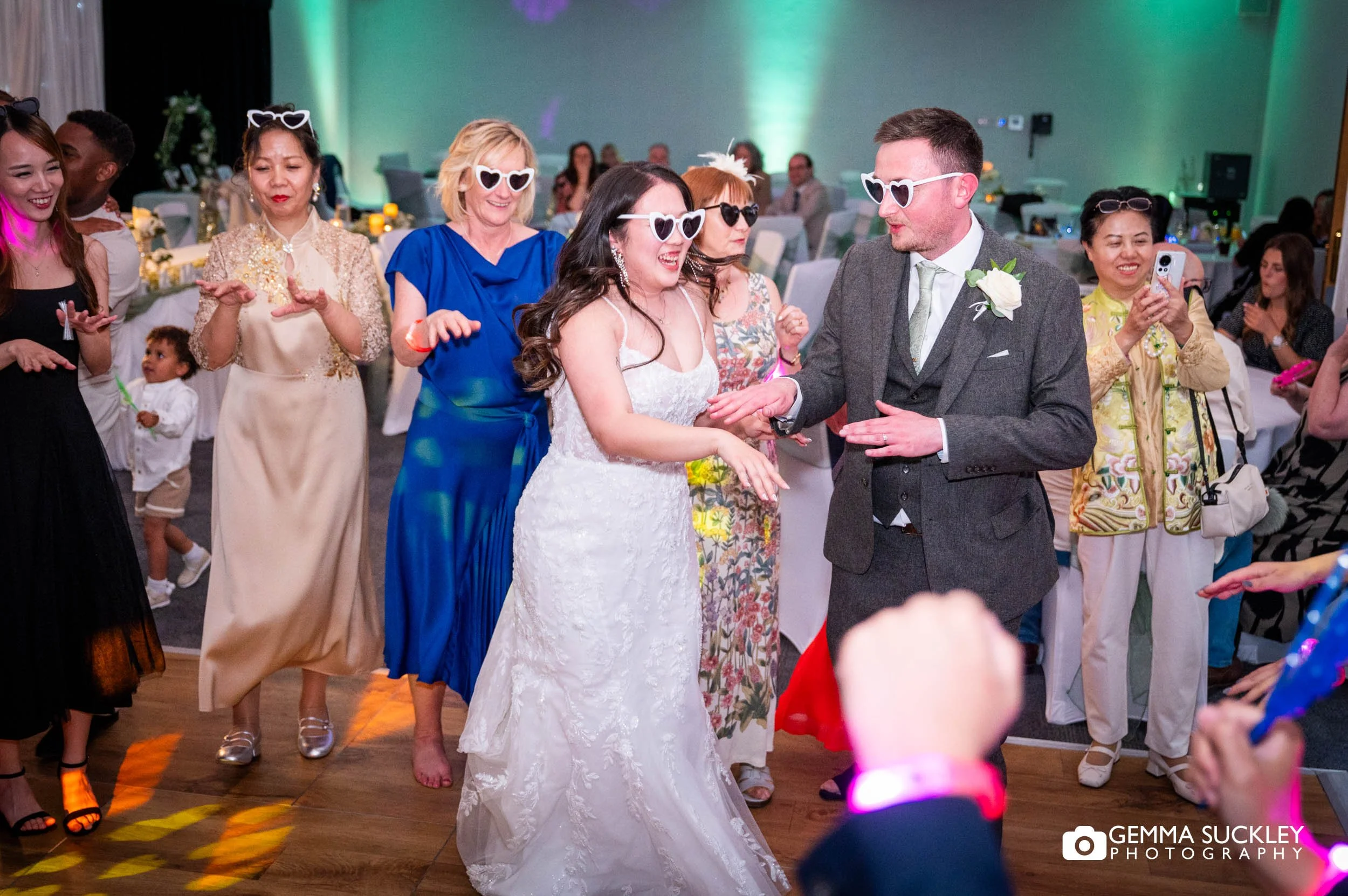 wedding guests dancing with the married couple