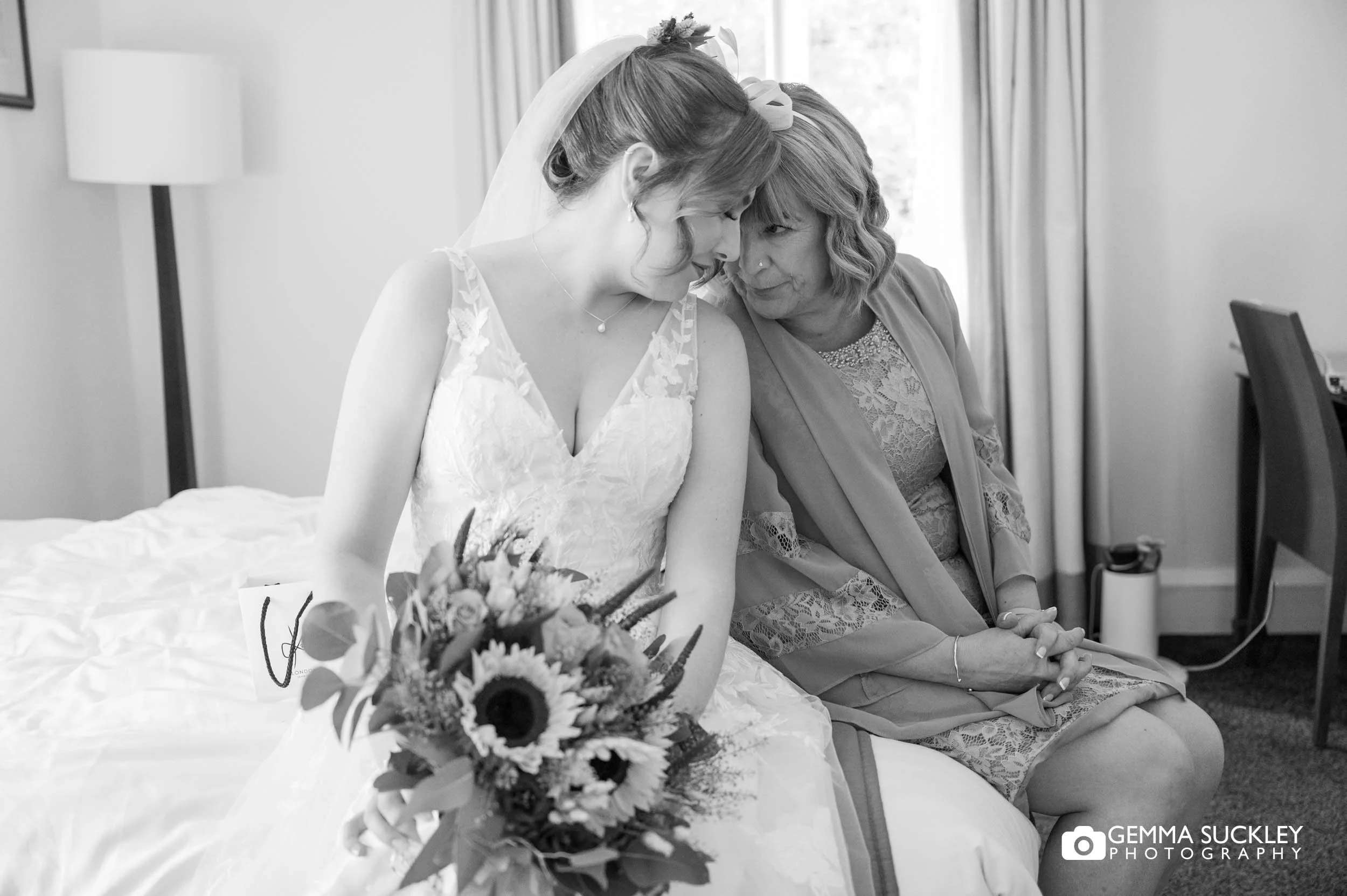 bride and mother share a quiet moment head to head