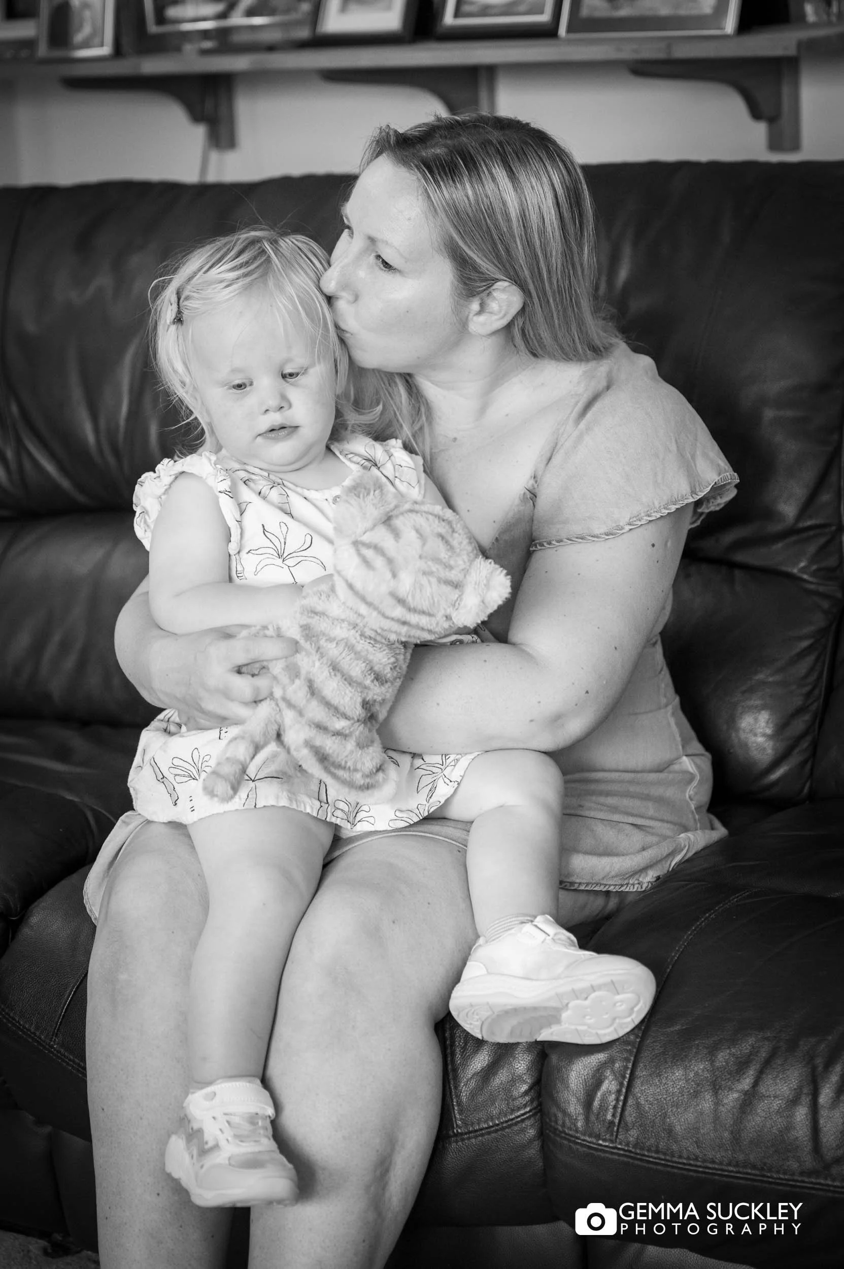 a mum kissing her baby 