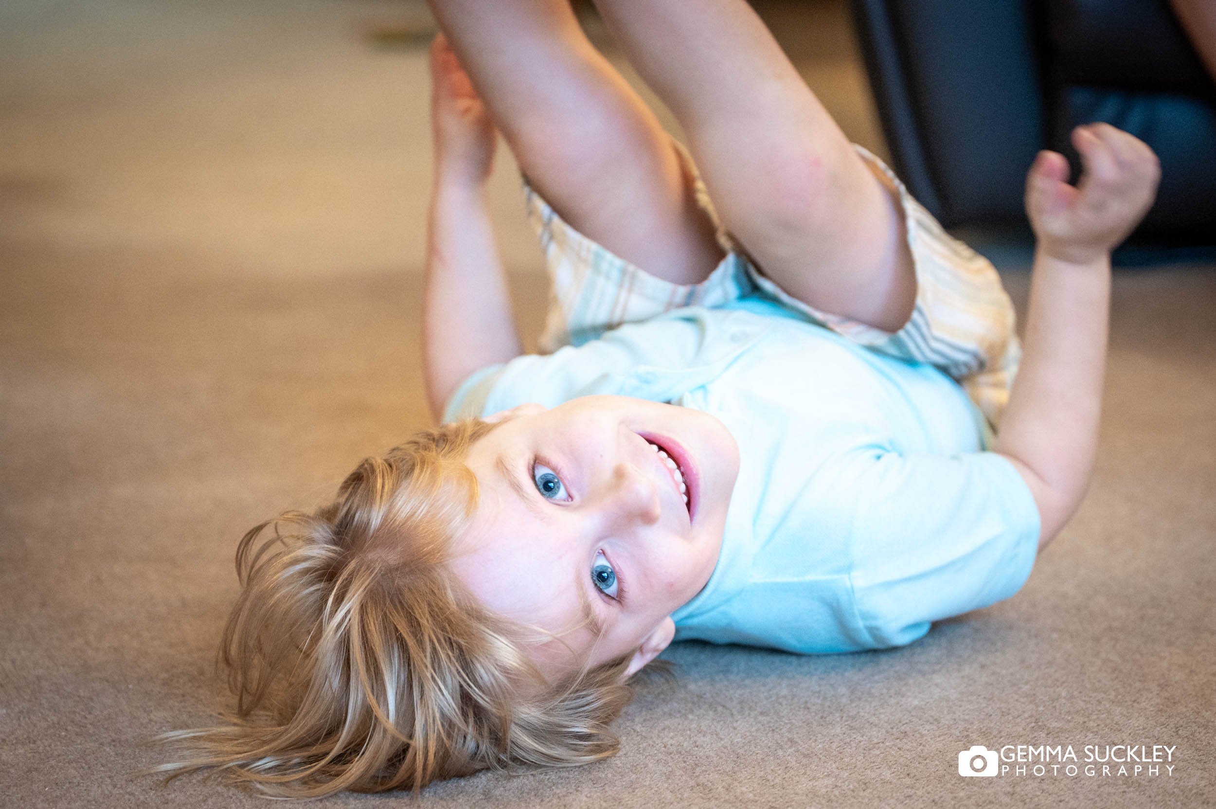 little boy rolling on the floor